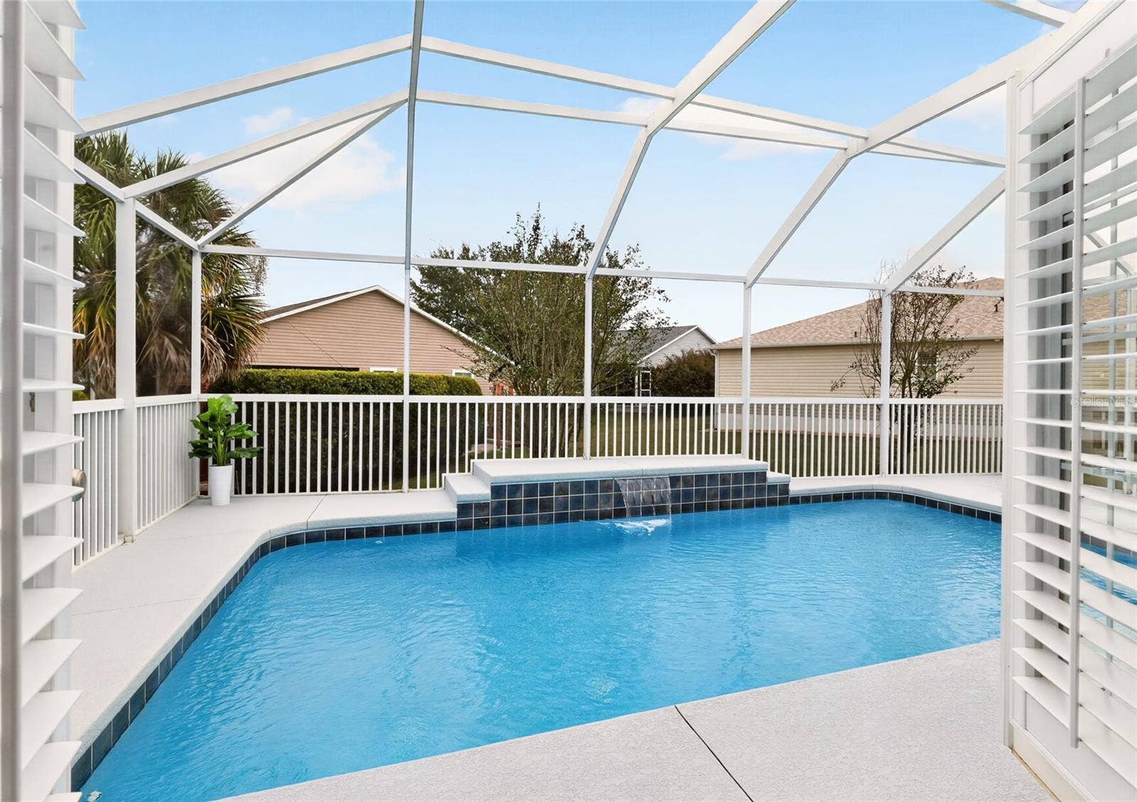 2454 MORNING DOVE LANE, The Villages, FL 32162 Step directly from the PRIMARY SUITE into your SCREENED POOL RETREAT, where sparkling water and a beautiful WATERFALL FEATURE invite you to relax and savor the Florida lifestyle!