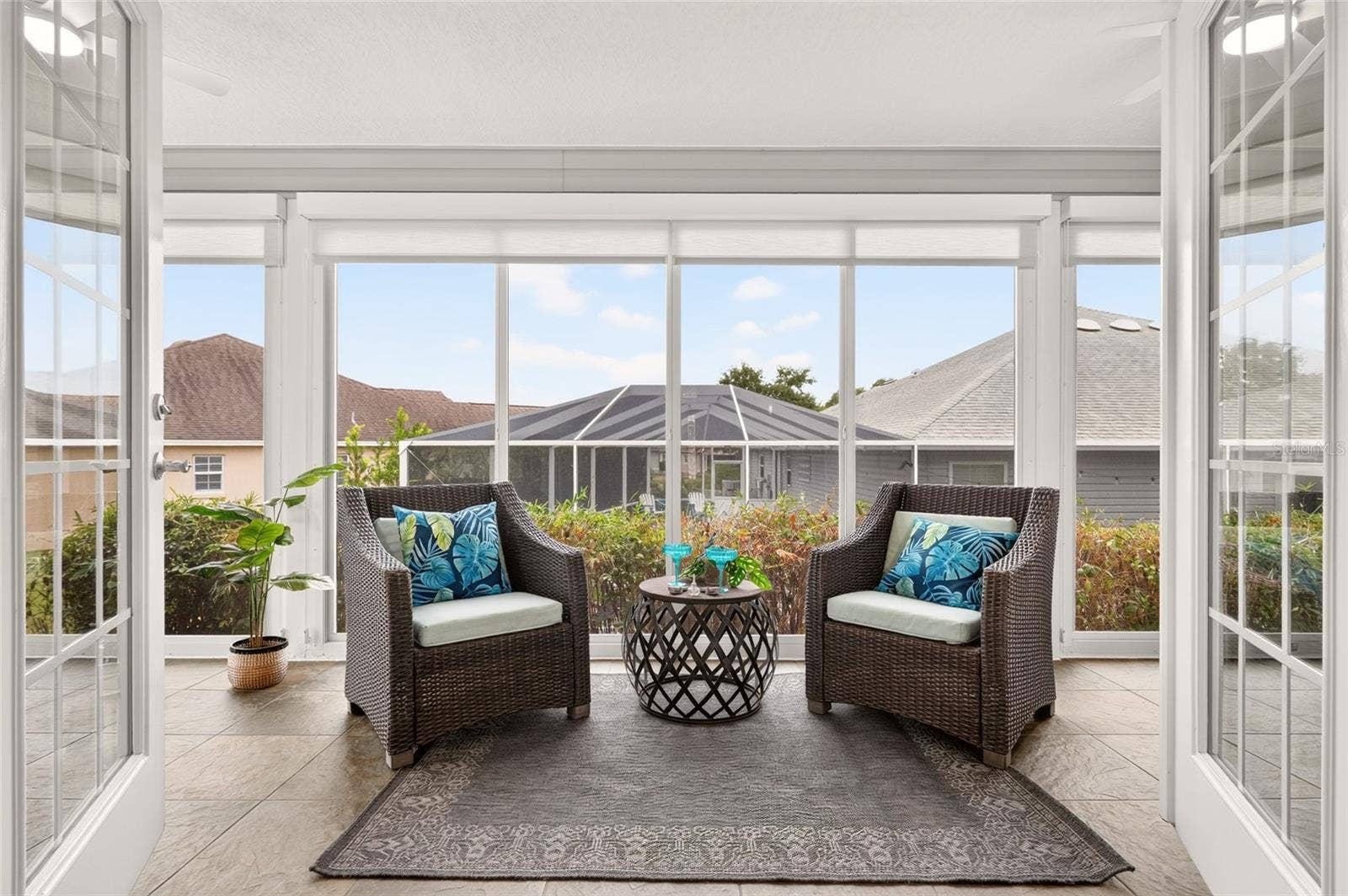 2454 MORNING DOVE LANE, The Villages, FL 32162 The sun-filled ENCLOSED LANAI features expansive windows, beautiful tile flooring, and access to the outdoor patioan inviting setting for morning coffee, quiet reading, or conversation with friends.