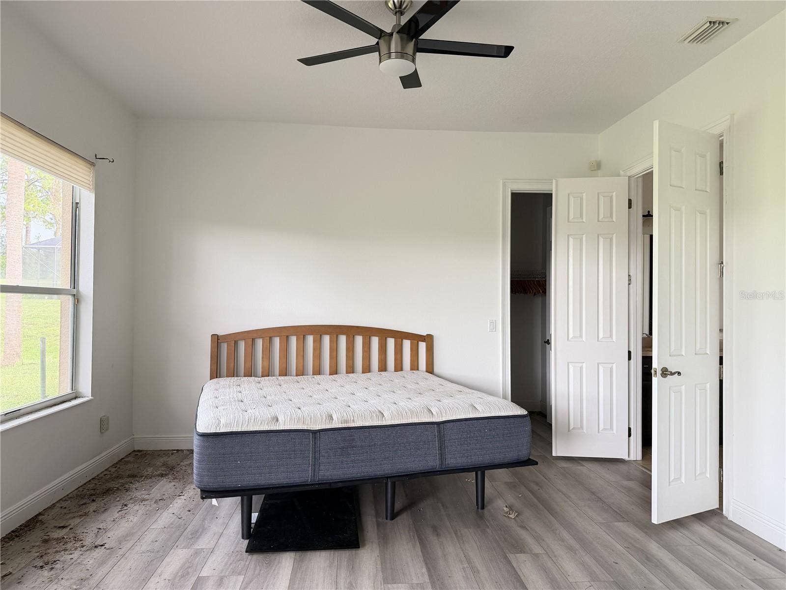 39539 HARBOR HILLS BOULEVARD, Lady Lake, FL 32159 Main-floor primary bedroom with luxury vinyl flooring and ceiling fan.