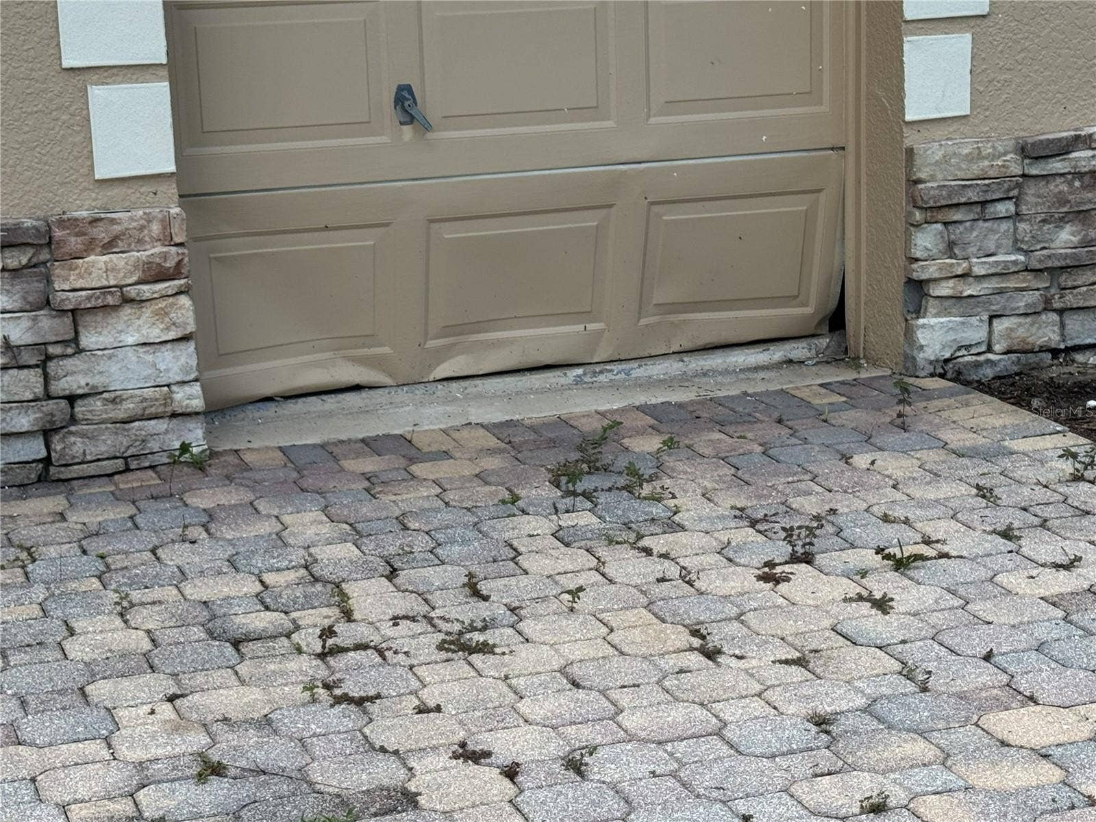 39539 HARBOR HILLS BOULEVARD, Lady Lake, FL 32159 Damage to lower panels of golf cart garage door.