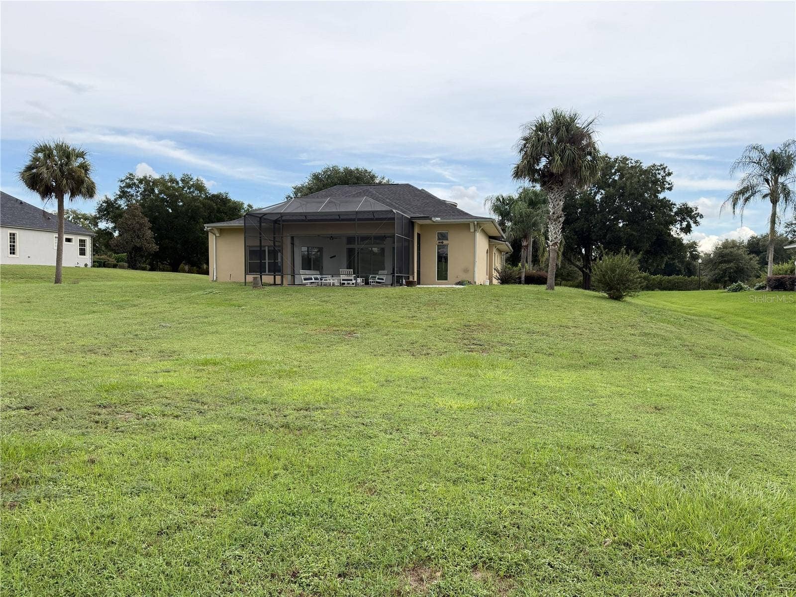 39539 HARBOR HILLS BOULEVARD, Lady Lake, FL 32159 Rear lawn of the 0.63-acre homesite adjoining the Harbor Hills golf course.