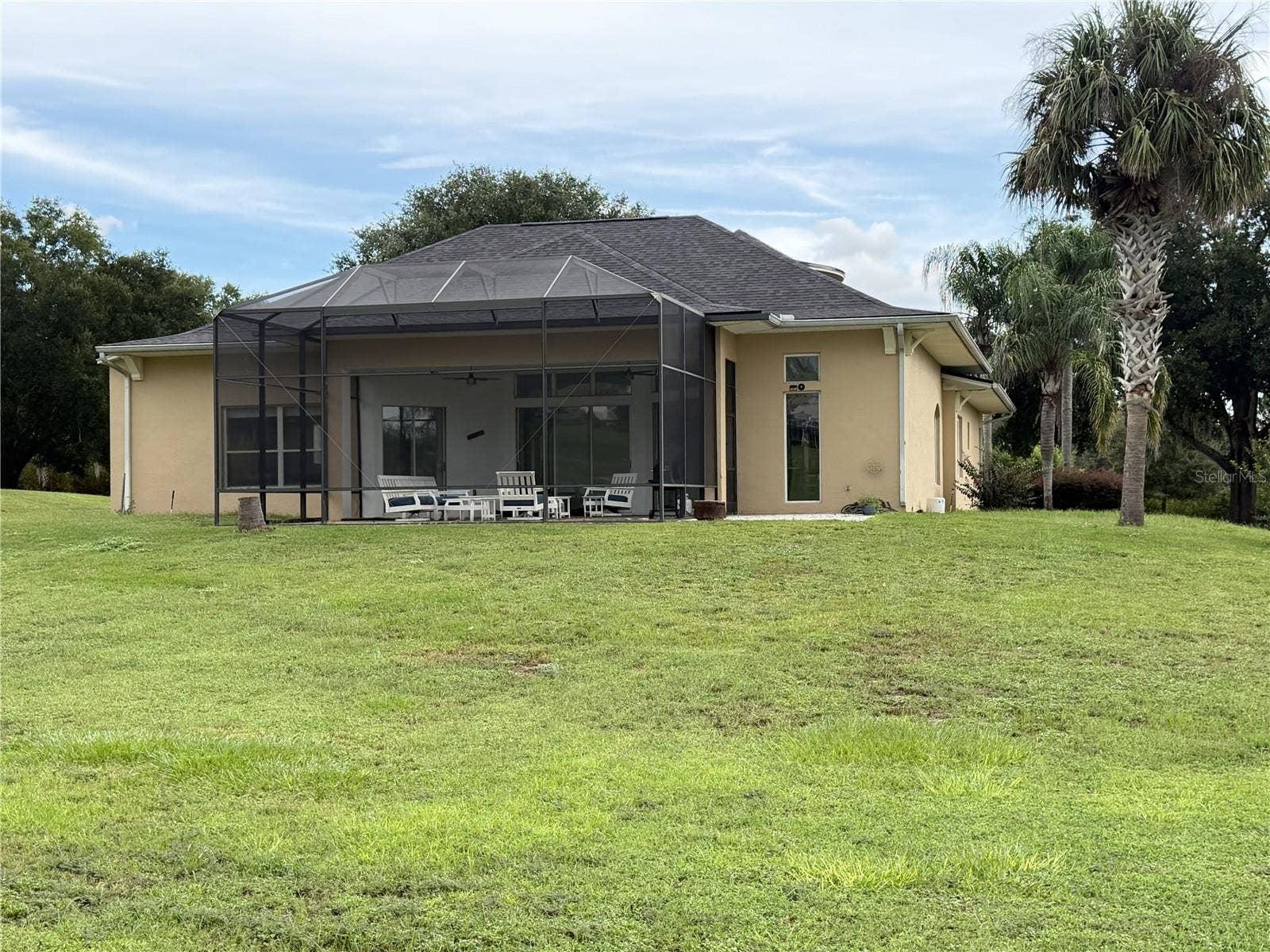 39539 HARBOR HILLS BOULEVARD, Lady Lake, FL 32159 Rear elevation with screened lanai and expansive lawn.