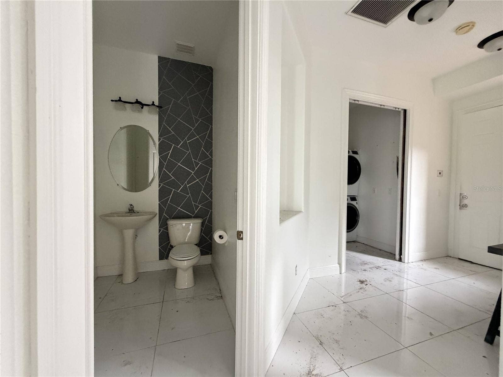 39539 HARBOR HILLS BOULEVARD, Lady Lake, FL 32159 Half bathroom with pedestal sink and decorative accent wall.