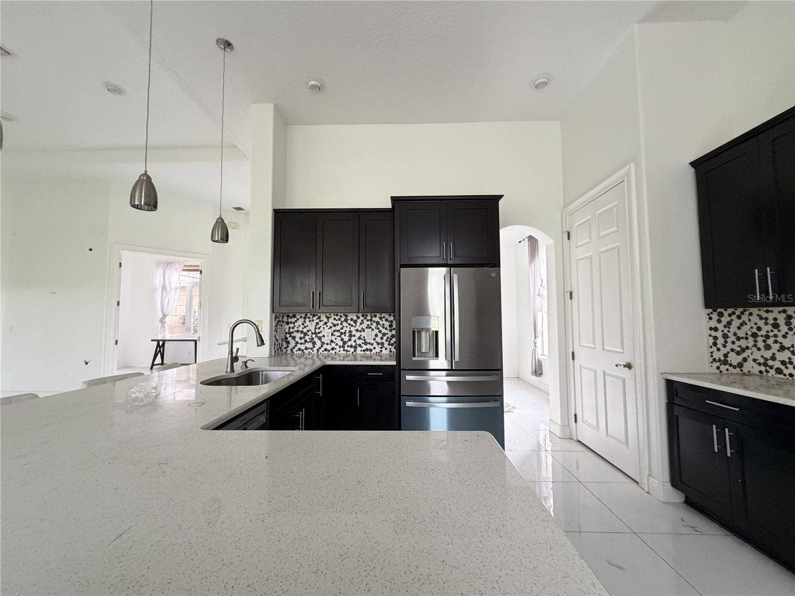 39539 HARBOR HILLS BOULEVARD, Lady Lake, FL 32159 Dark cabinets, light countertops, stainless-steel appliances, and sink.