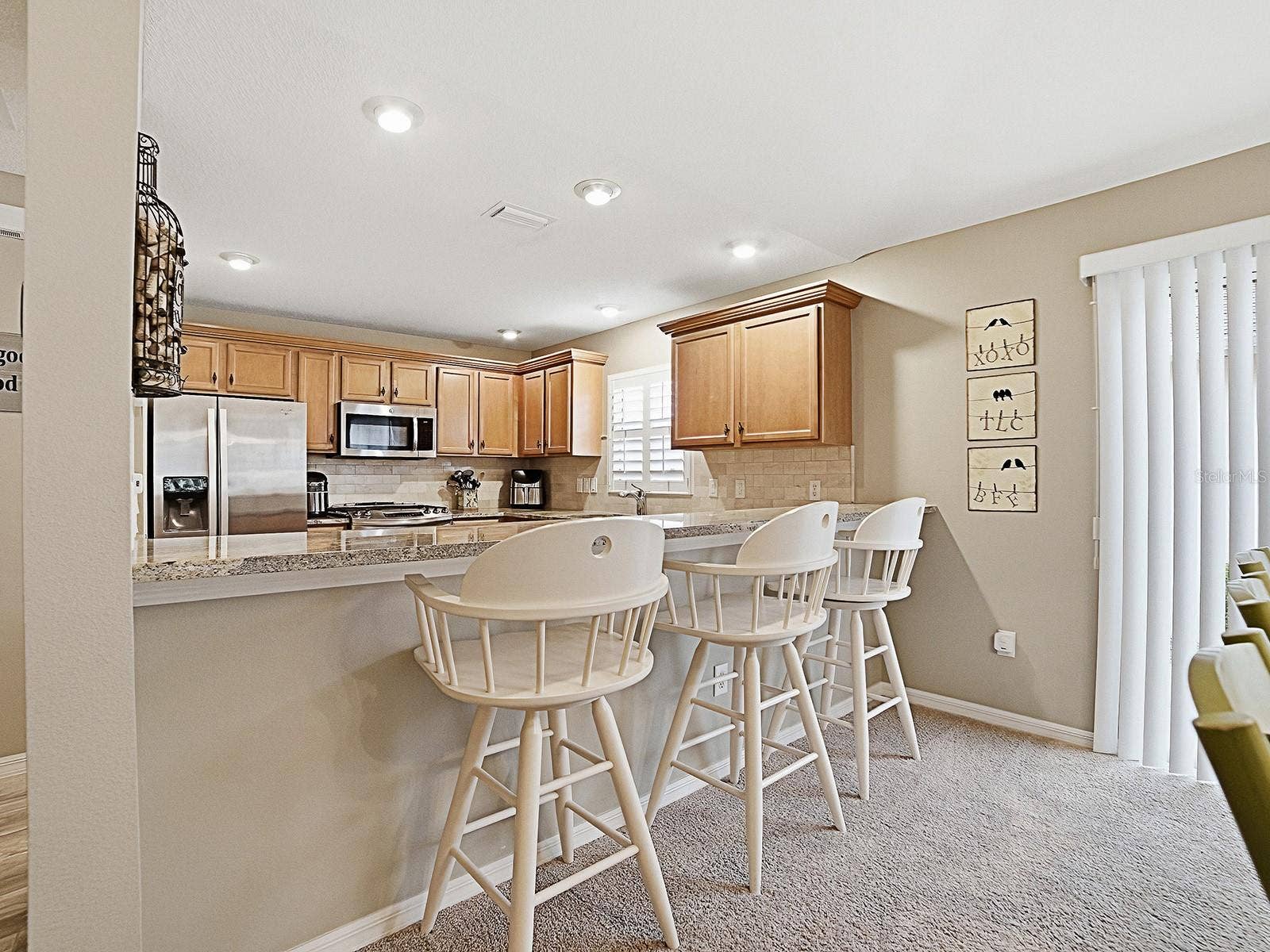 1530 BARNWELL PLACE, The Villages, FL 32162 Enjoy the breakfast bar with sliding doors to patio