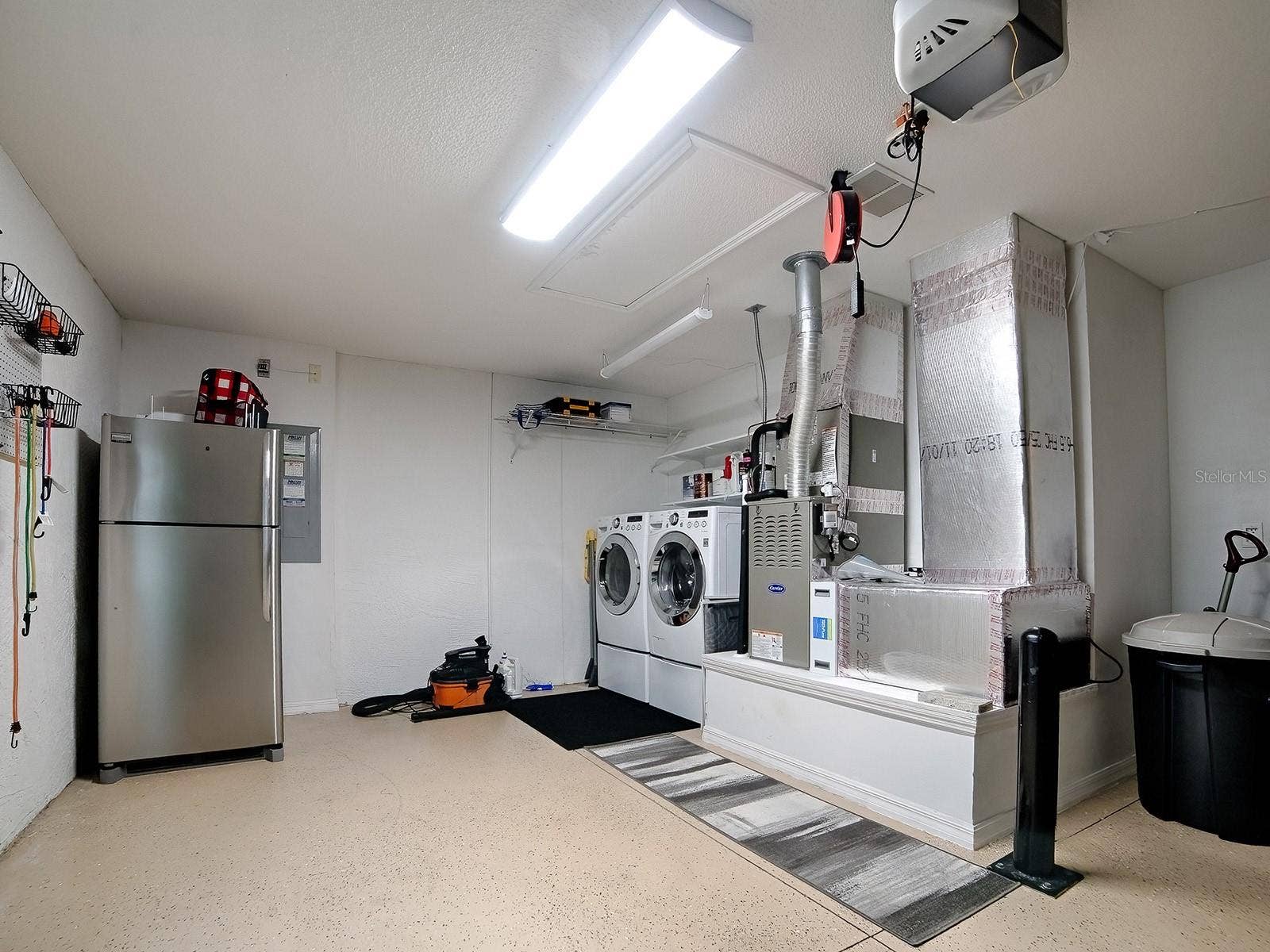 1530 BARNWELL PLACE, The Villages, FL 32162 Clean and efficient Laundry space with extra refrigerator when those guests show up