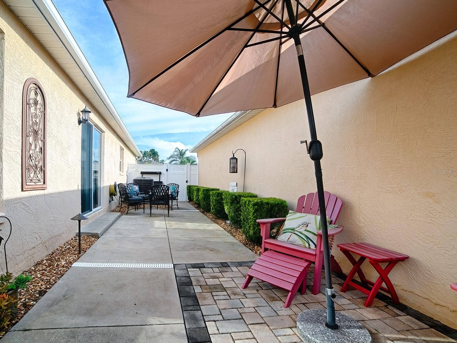 1530 BARNWELL PLACE, The Villages, FL 32162 Side patio entertaining space with easy access back inside via dining room patio door