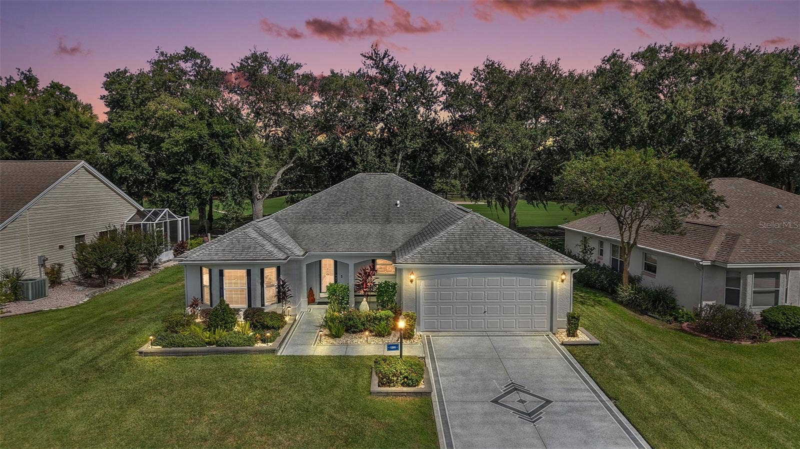 1201 BARCELONA DRIVE, The Villages, FL 32159 Twilight Front Elevation with Golf Front Views