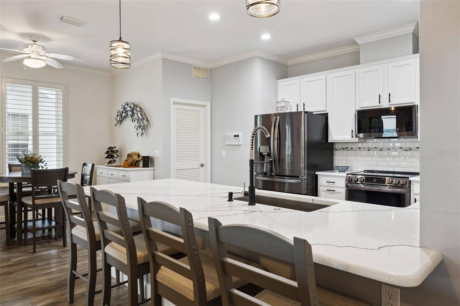 3210 SARATOGA DRIVE, Tavares, FL 32778 Beautifully updated kitchen featuring quartz countertops, a spacious breakfast bar, stainless steel appliances, and plenty of room for gathering!