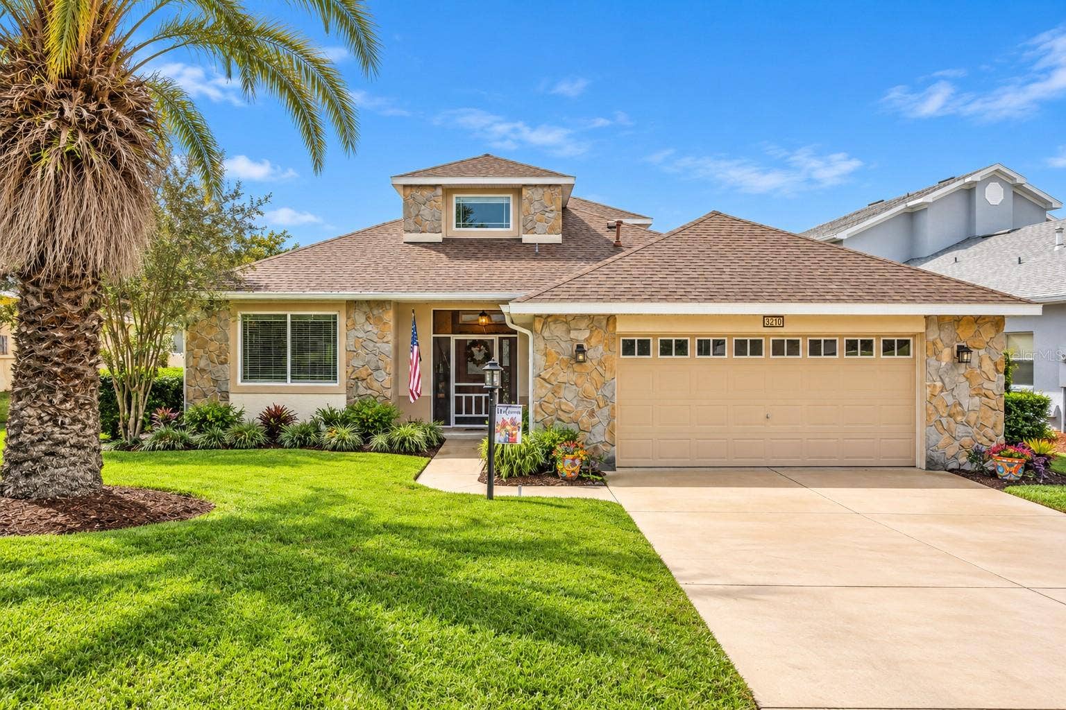 3210 SARATOGA DRIVE, Tavares, FL 32778 This well-built block home features attractive stone accents, tropical landscaping, and a welcoming entrance.