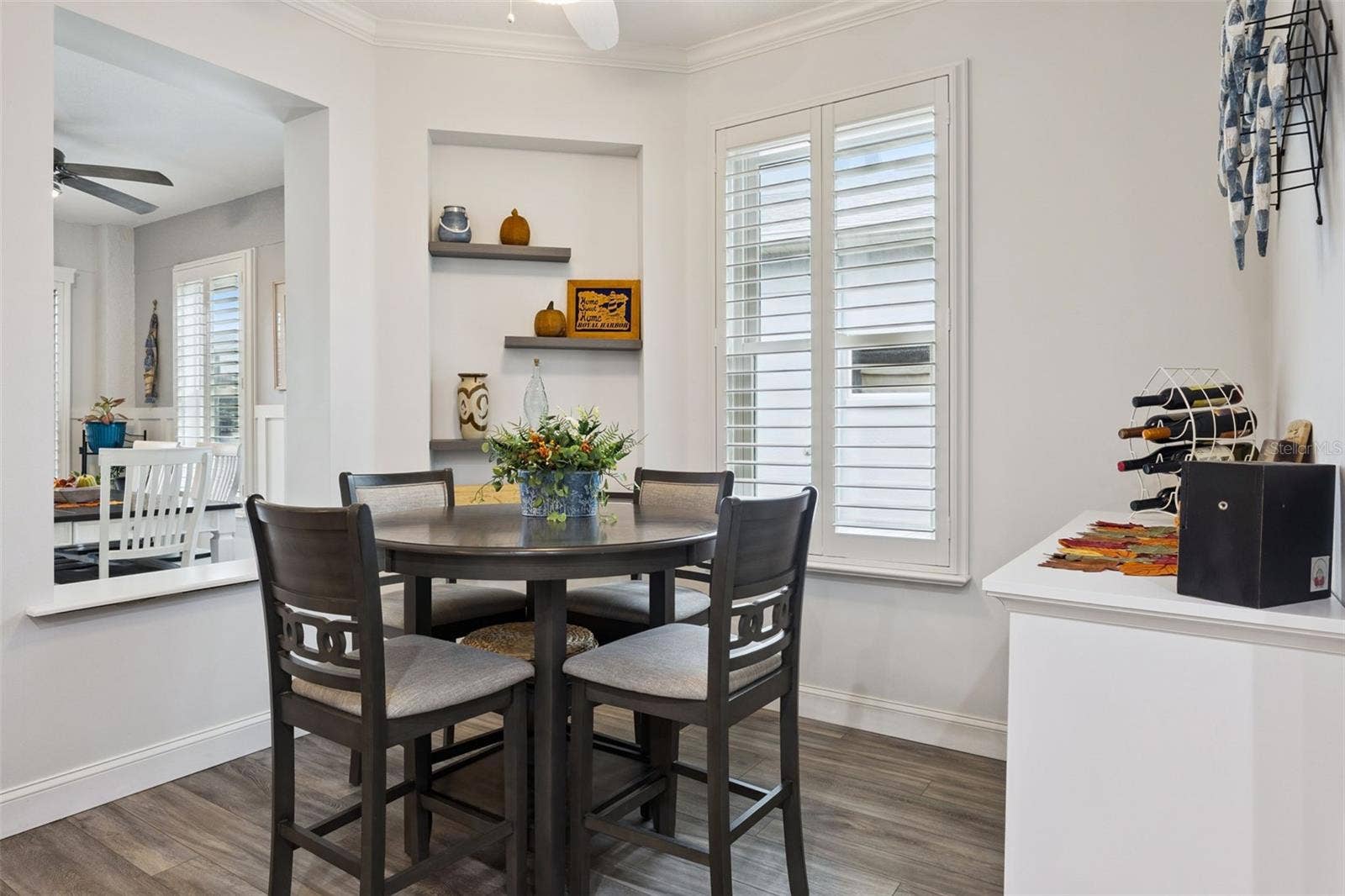 3210 SARATOGA DRIVE, Tavares, FL 32778 A cozy breakfast nook for morning coffee, with plantation shutters adding timeless style throughout the home.