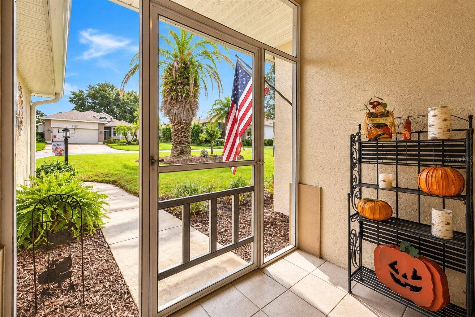 3210 SARATOGA DRIVE, Tavares, FL 32778 A cozy enclosed front porch offers a warm welcome and the perfect spot to enjoy a little peace and quiet!
