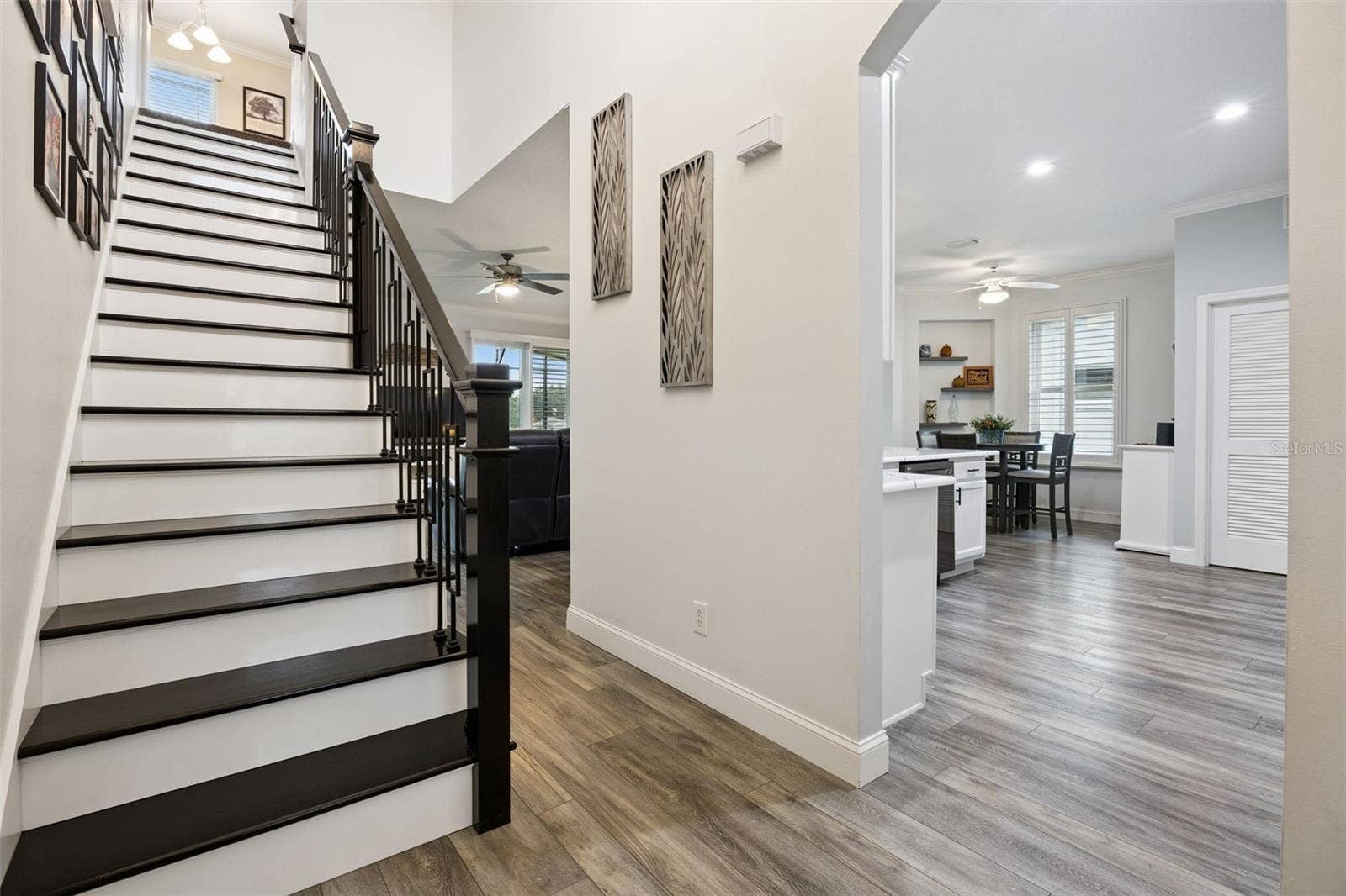 3210 SARATOGA DRIVE, Tavares, FL 32778 A $1,500 upgrade refreshed the stairs and railing leading to the versatile upstairs loft/bonus room