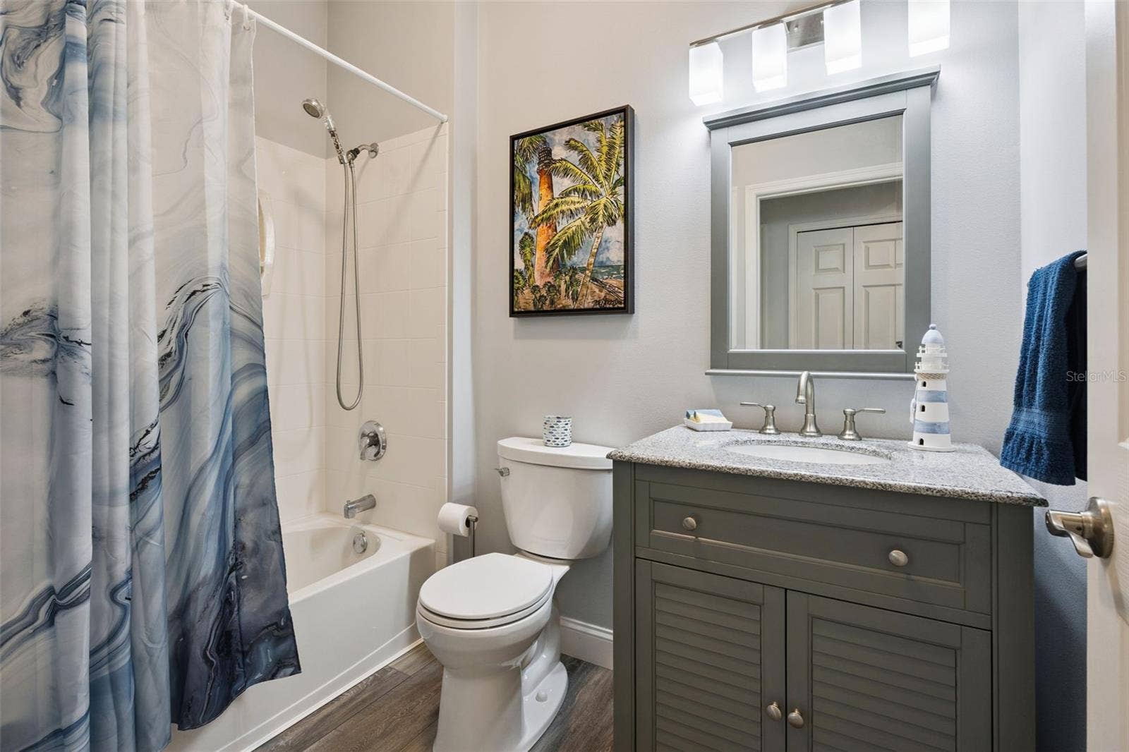 3210 SARATOGA DRIVE, Tavares, FL 32778 Guest Bathroom has upgraded flooring and vanity