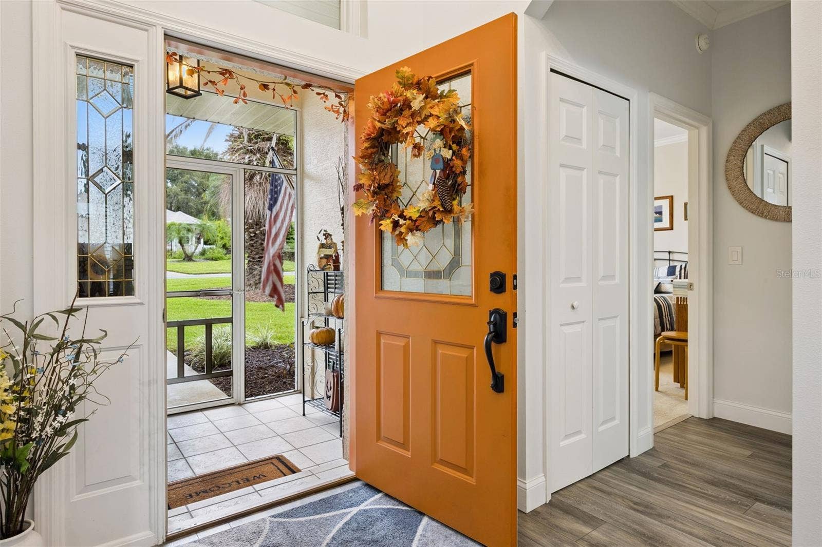 3210 SARATOGA DRIVE, Tavares, FL 32778 A warm and welcoming entryway with a charming front door, decorative glass accents, and an inviting first impression!
