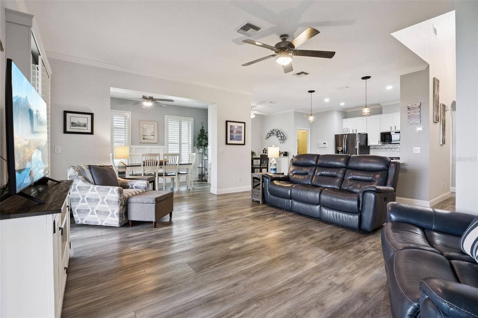 3210 SARATOGA DRIVE, Tavares, FL 32778 Cohesive neutral paint and flooring create a seamless flow throughout the open-concept living spaces