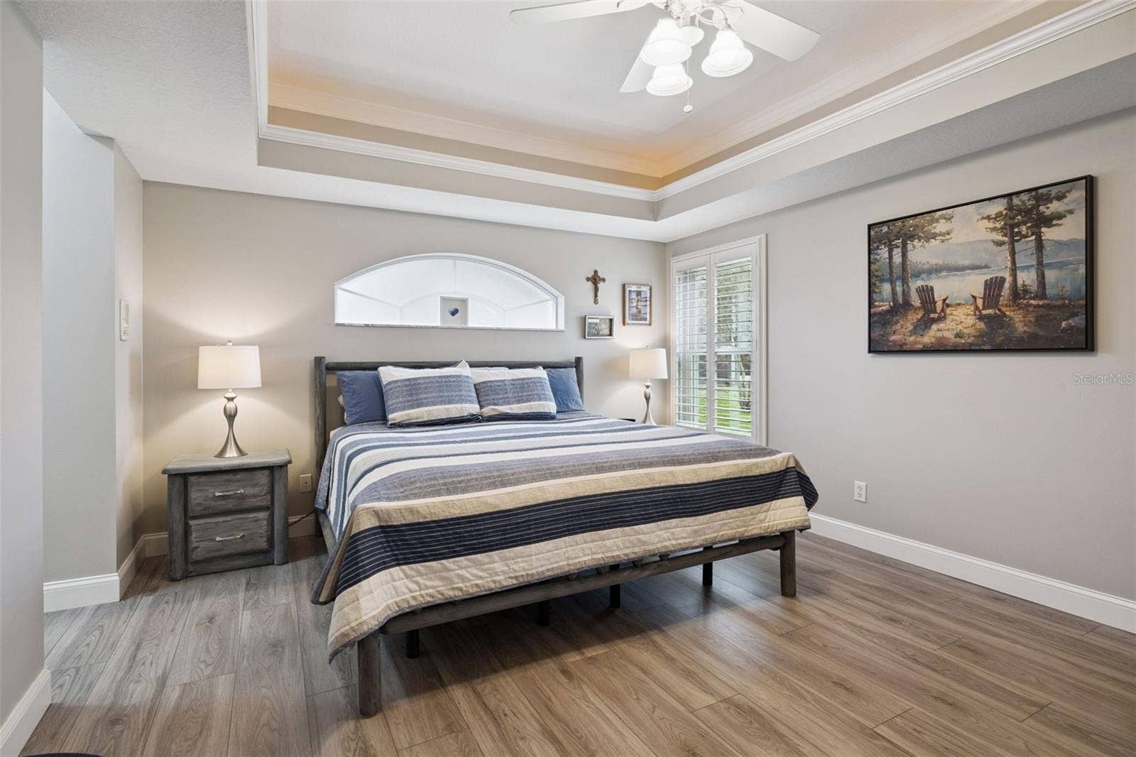 3210 SARATOGA DRIVE, Tavares, FL 32778 A tray ceiling with soft accent lighting adds depth and a relaxing glow to the primary suite
