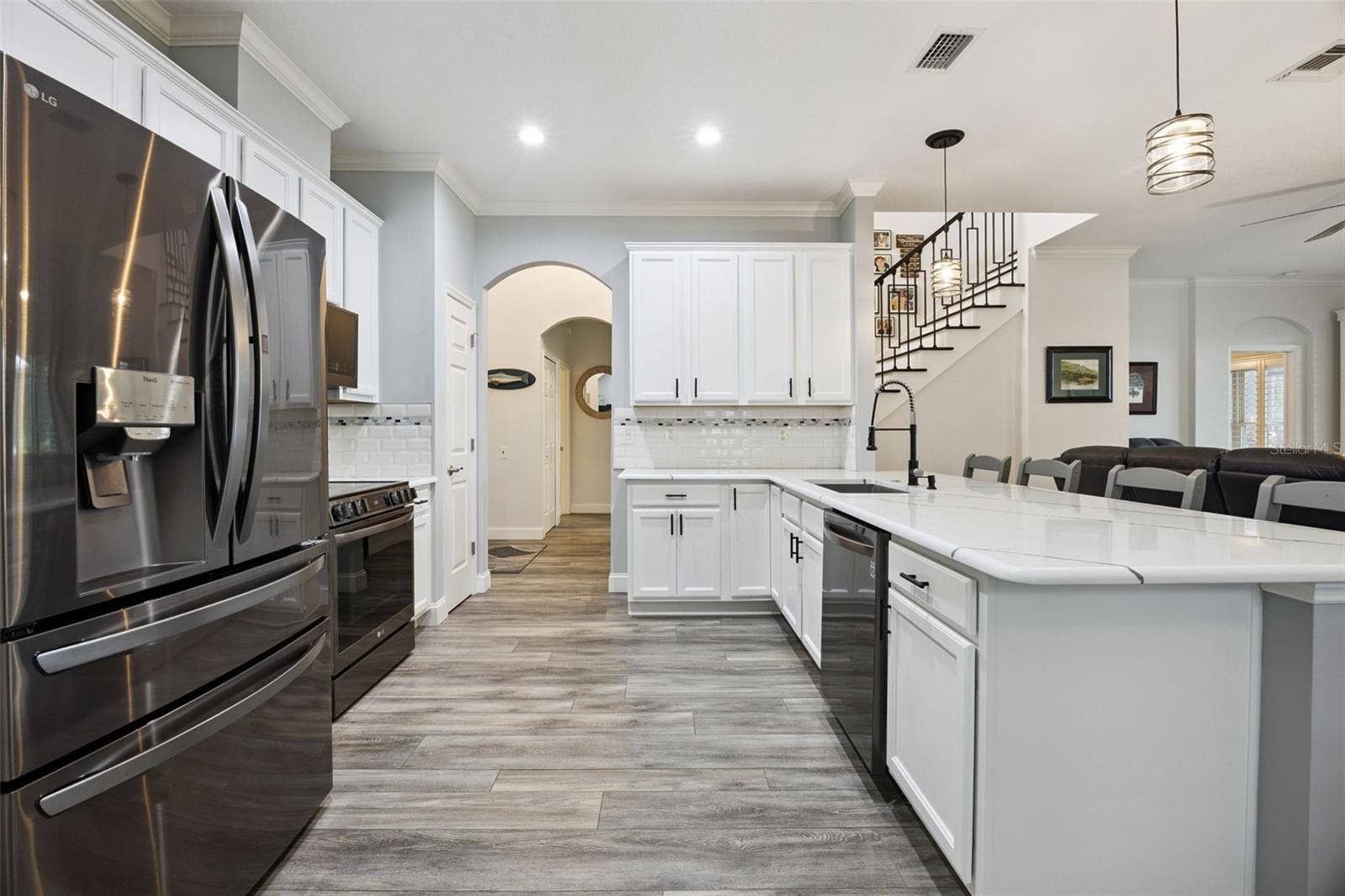 3210 SARATOGA DRIVE, Tavares, FL 32778 Upgraded luxury vinyl plank flooring adds a fresh, cohesive look throughout the kitchen and main living spaces.