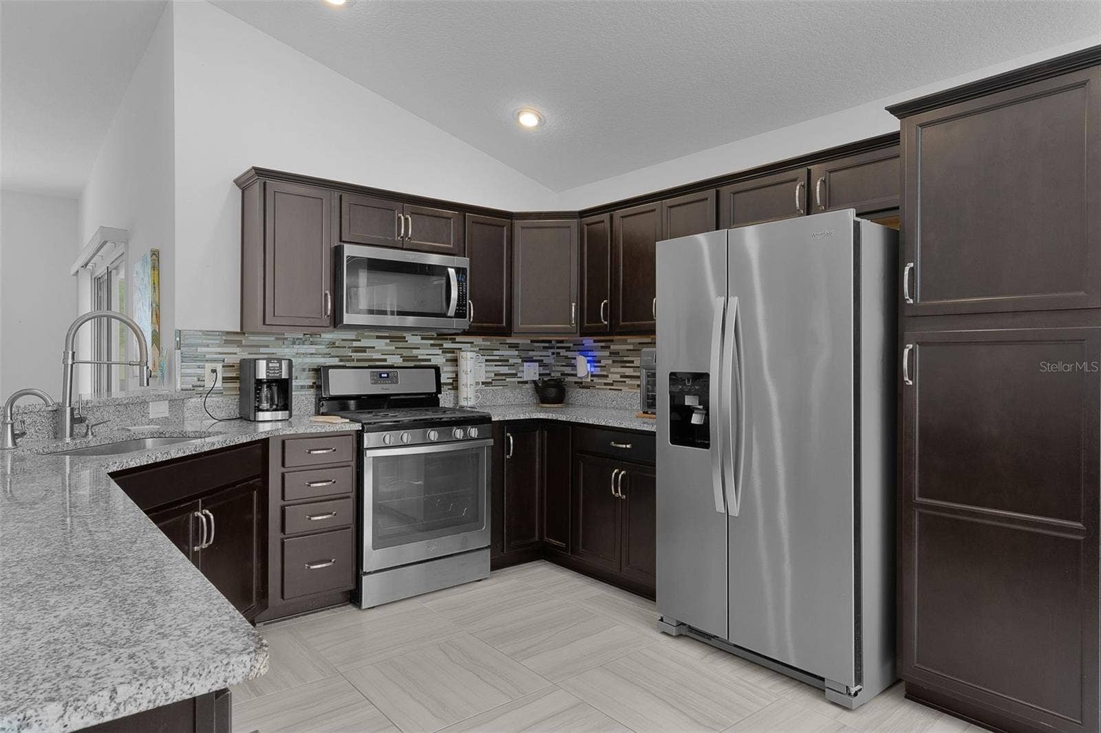 Stainless steel appliances, espresso color cabinets with hardware & backsplash & pantry cabinet