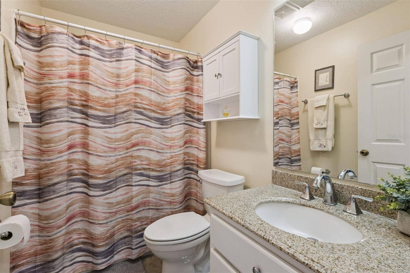 21736 PRINCESS GRACE COURT, Leesburg, FL 34748 BATHROOM 2 has SOLID-SURFACE COUNTER, TUB/SHOWER COMBO and a WINDOW.