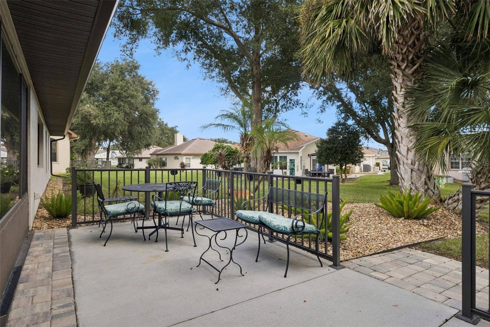 21736 PRINCESS GRACE COURT, Leesburg, FL 34748 REAR PATIO leads to a BEAUTIFUL PARK-LIKE BACKYARD.