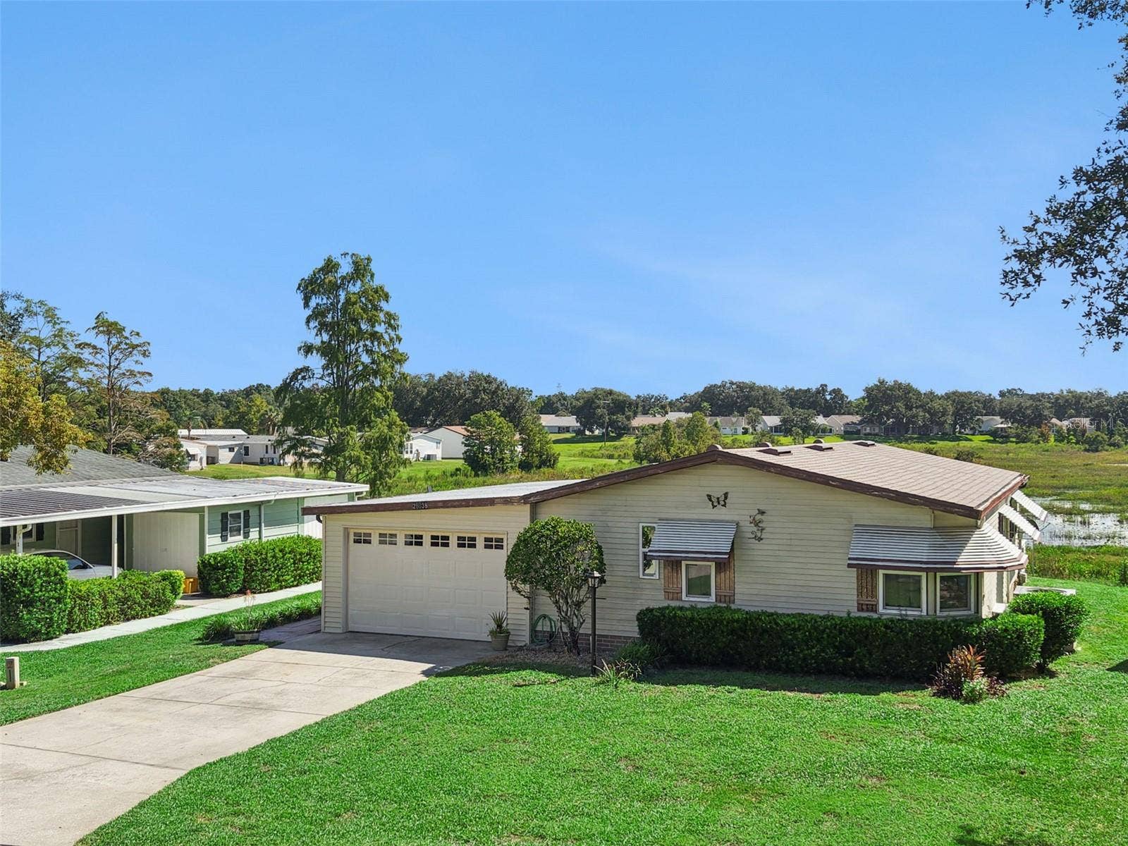 Elevated front view of the home and garage with the marsh beyond