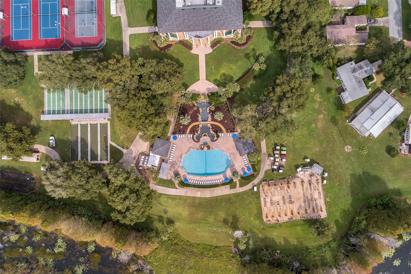 Community amenity: overhead view of the clubhouse, pool and game courts