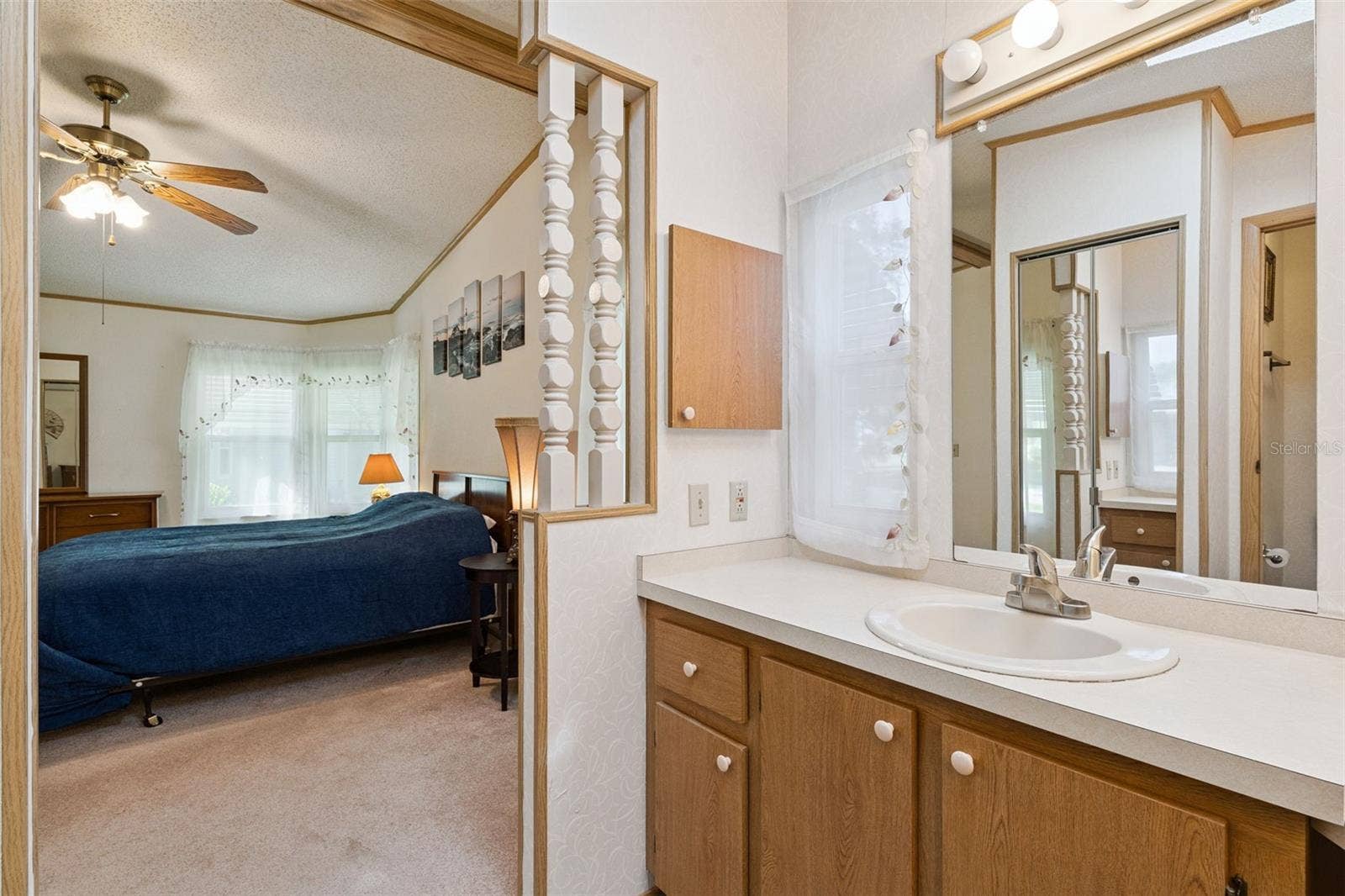 Primary bathroom vanity open to the primary bedroom