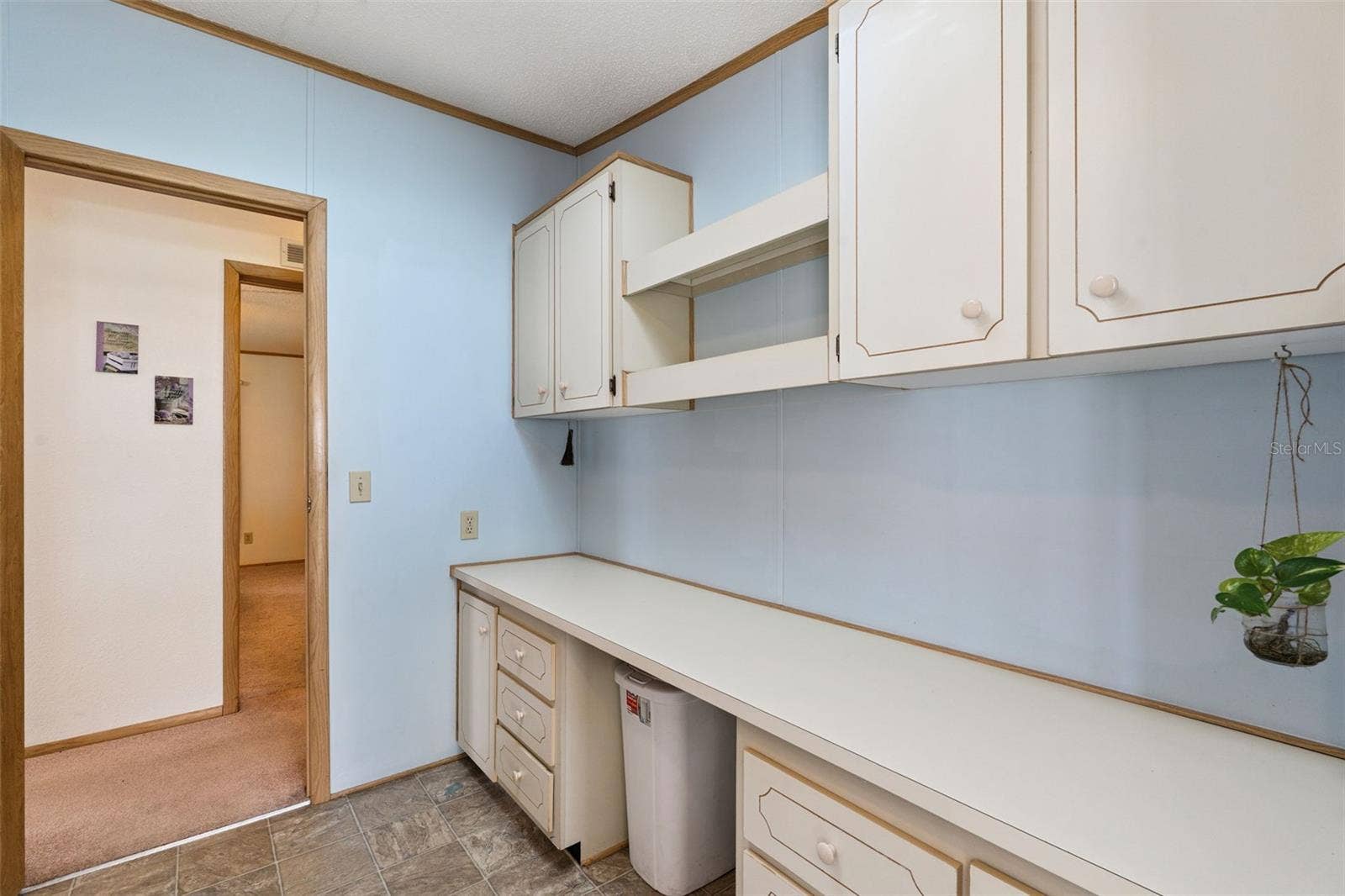 Laundry room with built-in counter, drawers and upper cabinets