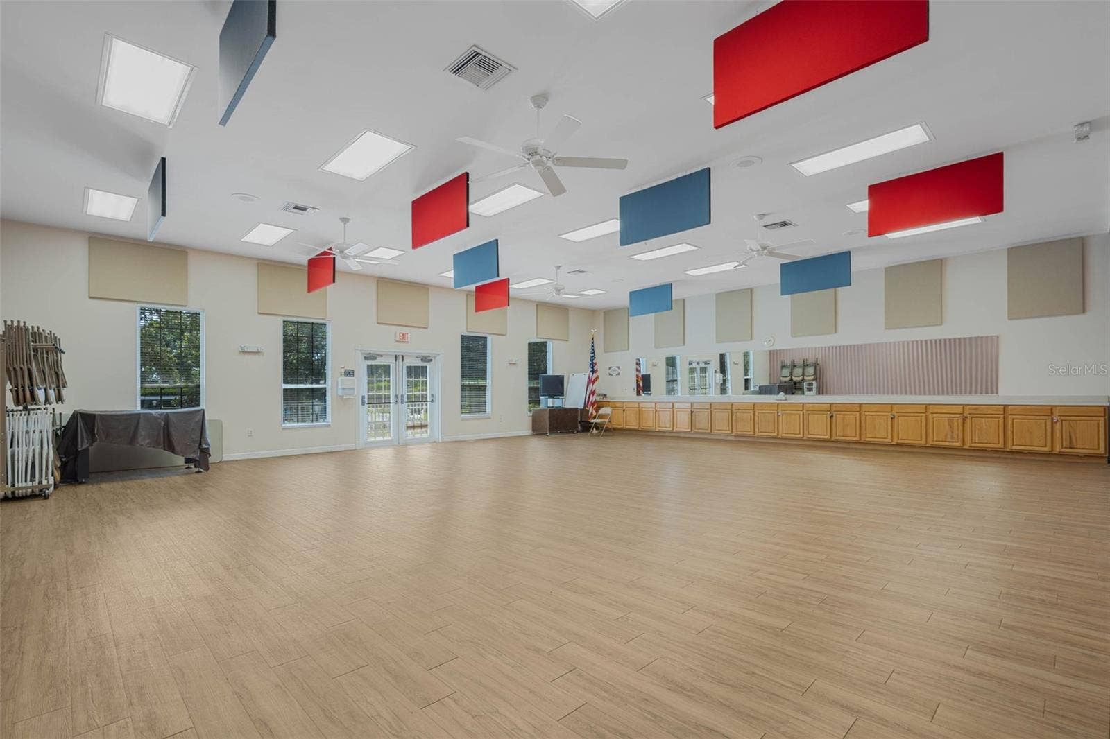 Community amenity: large activity room with wood-look flooring