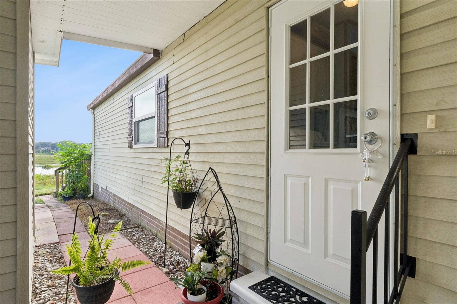 Side entry door and paver walkway leading to the backyard