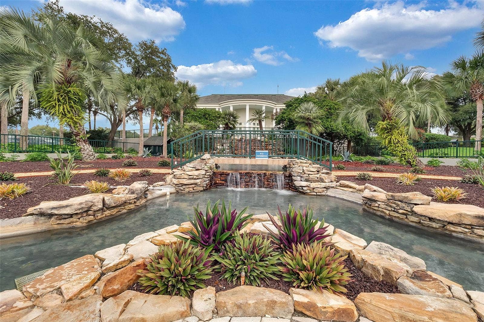 Community amenity: waterfall, landscaped garden and footbridge by the clubhouse