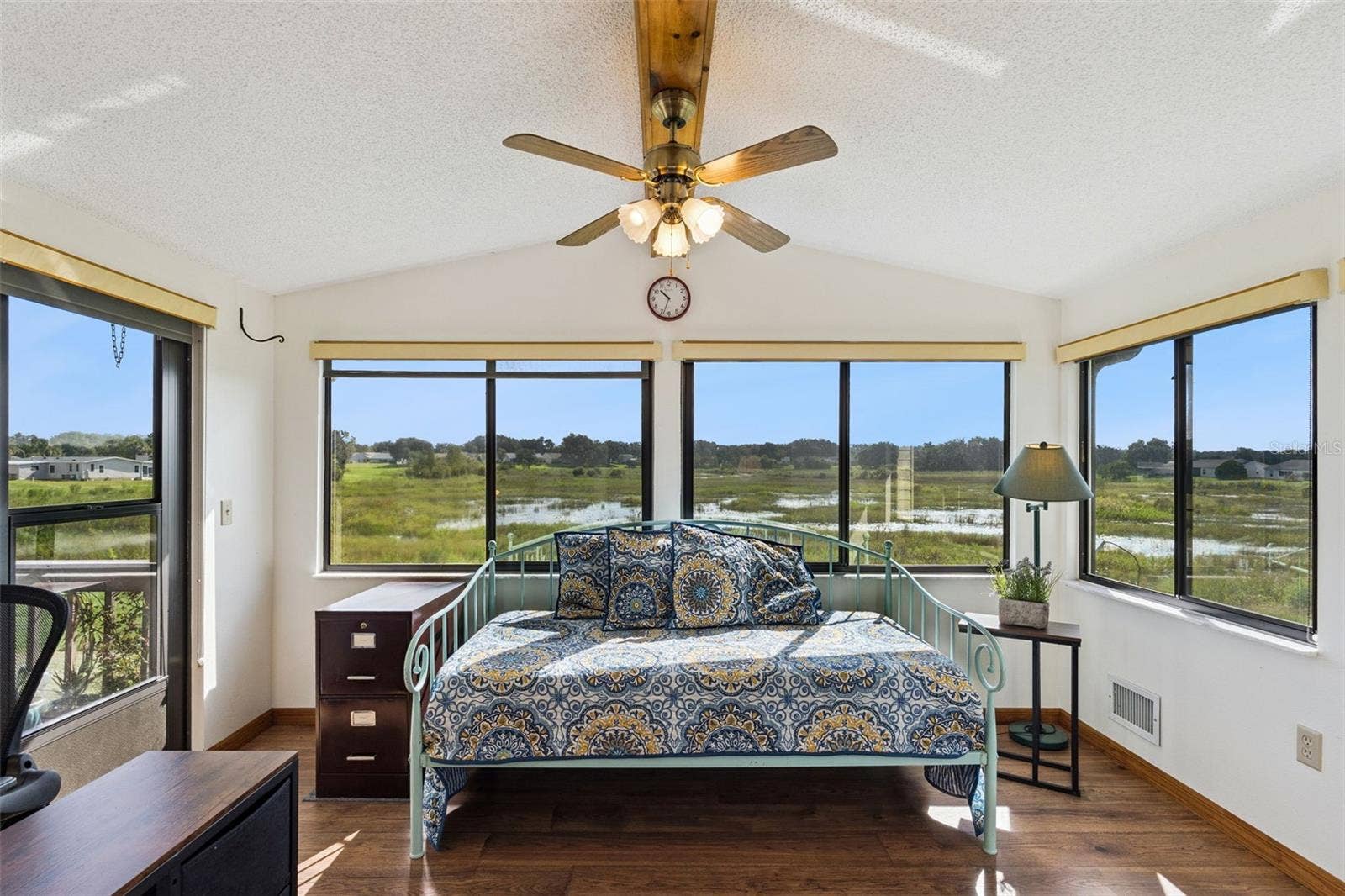 Sunroom with wide windows overlooking the open marsh