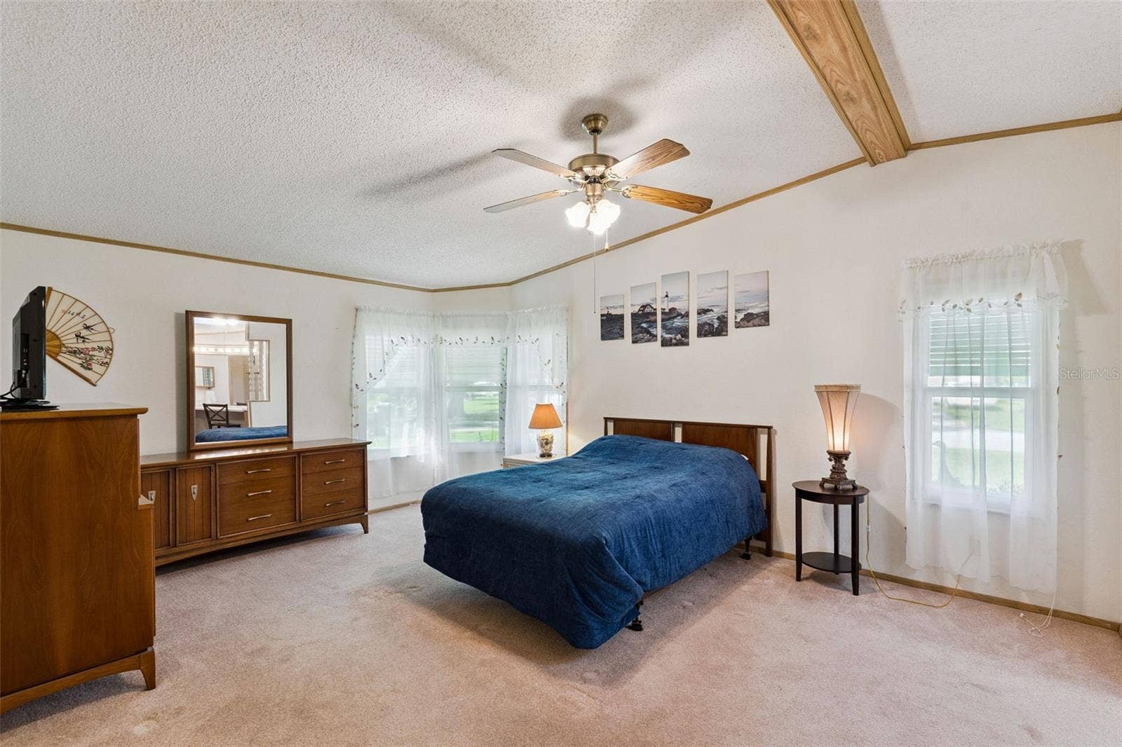 Spacious primary bedroom with corner windows and plenty of natural light
