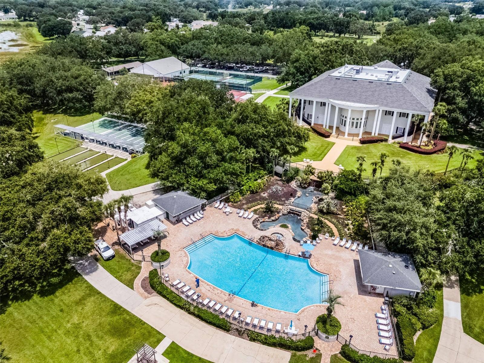 Community amenity: aerial view of the clubhouse, pool and courts