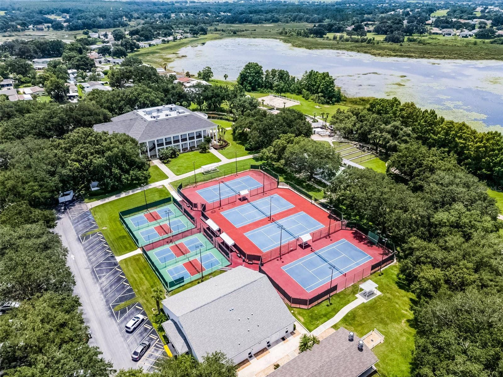 Community amenity: aerial view of the courts and clubhouse by the lake