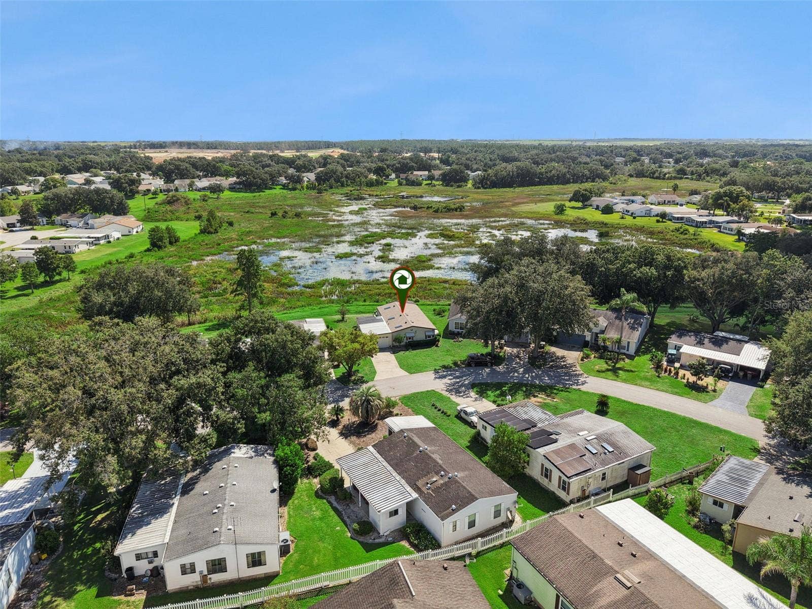 Aerial view across the neighborhood with the home marked