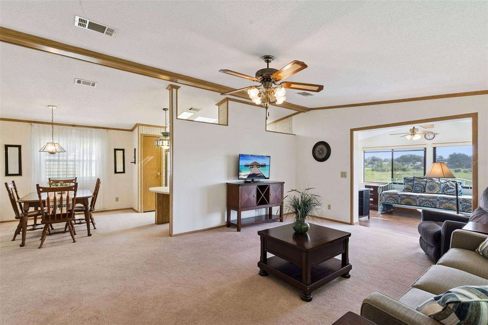 Open living area connecting the dining room and the sunroom