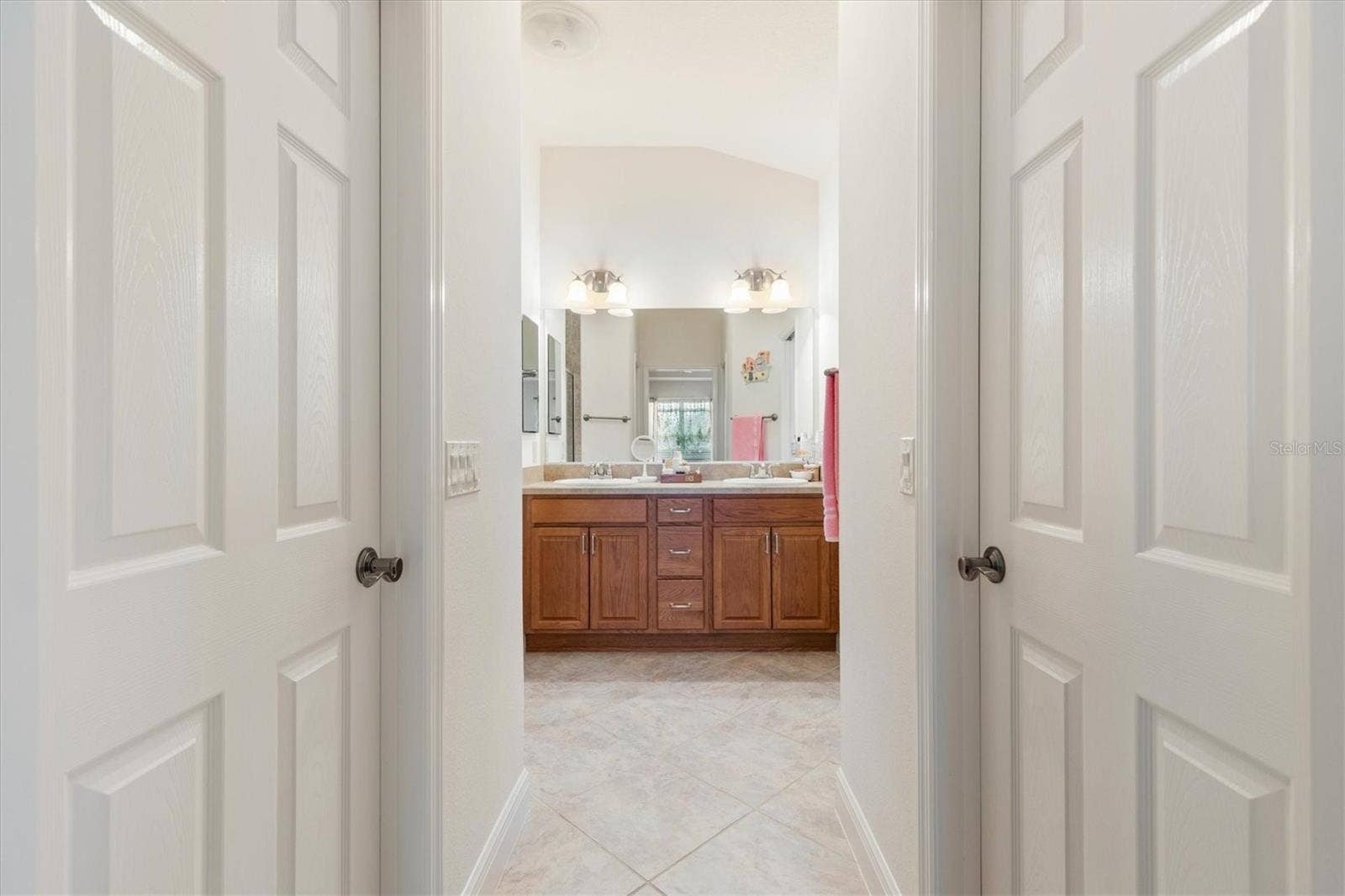 1926 ELDRIDGE LOOP, The Villages, FL 32162 Primary ensuite with two walk-in closets, walk-in shower, dual sinks, and private water closet.