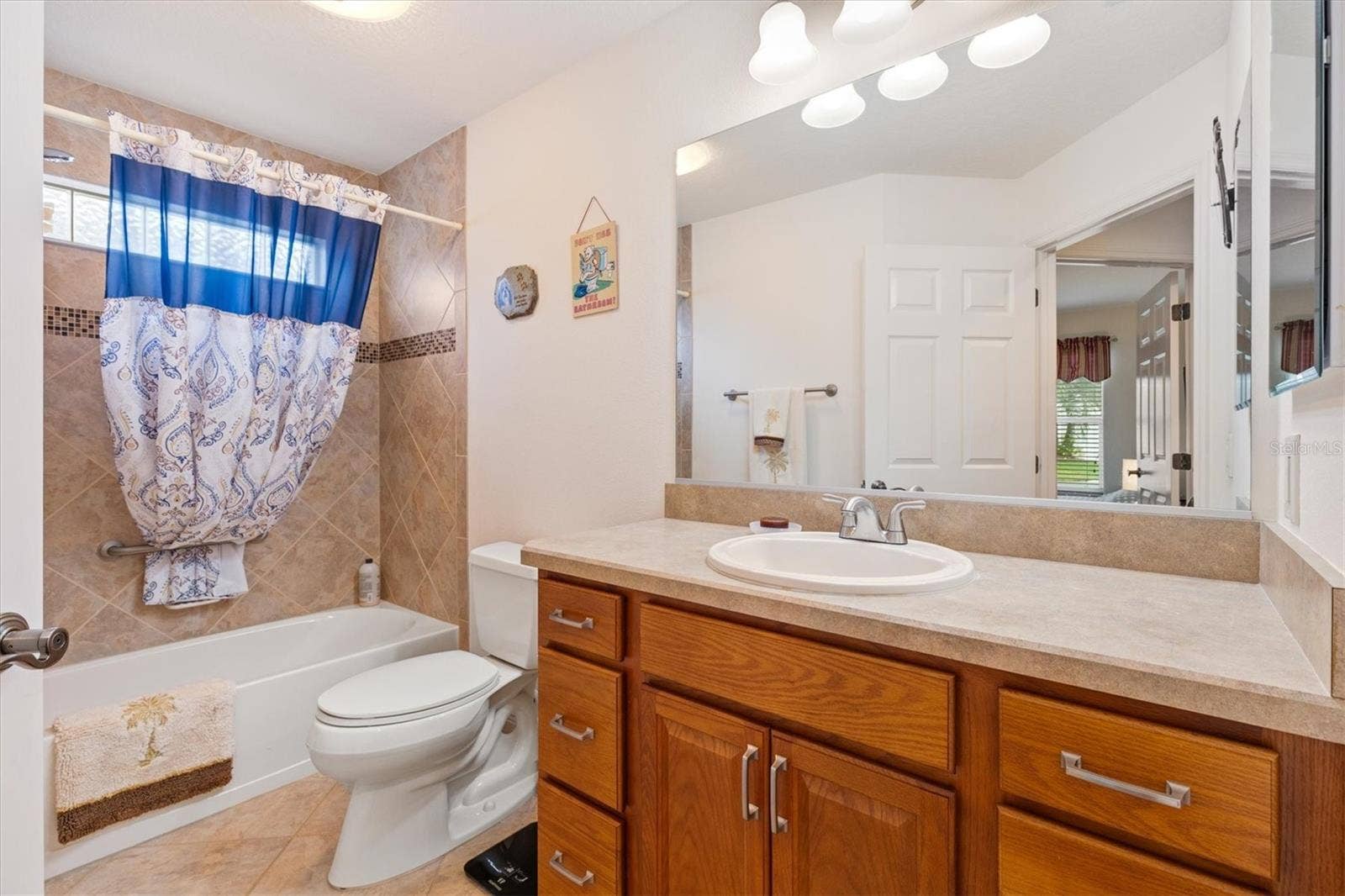 1926 ELDRIDGE LOOP, The Villages, FL 32162 Guest bath with tiled tub/shower combo.