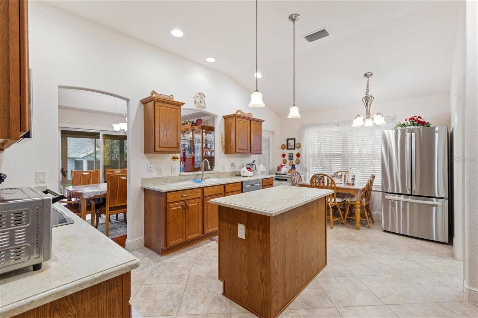 1926 ELDRIDGE LOOP, The Villages, FL 32162 Large Kitchen with two refrigerators, built-in oven, cooktop, and working island.