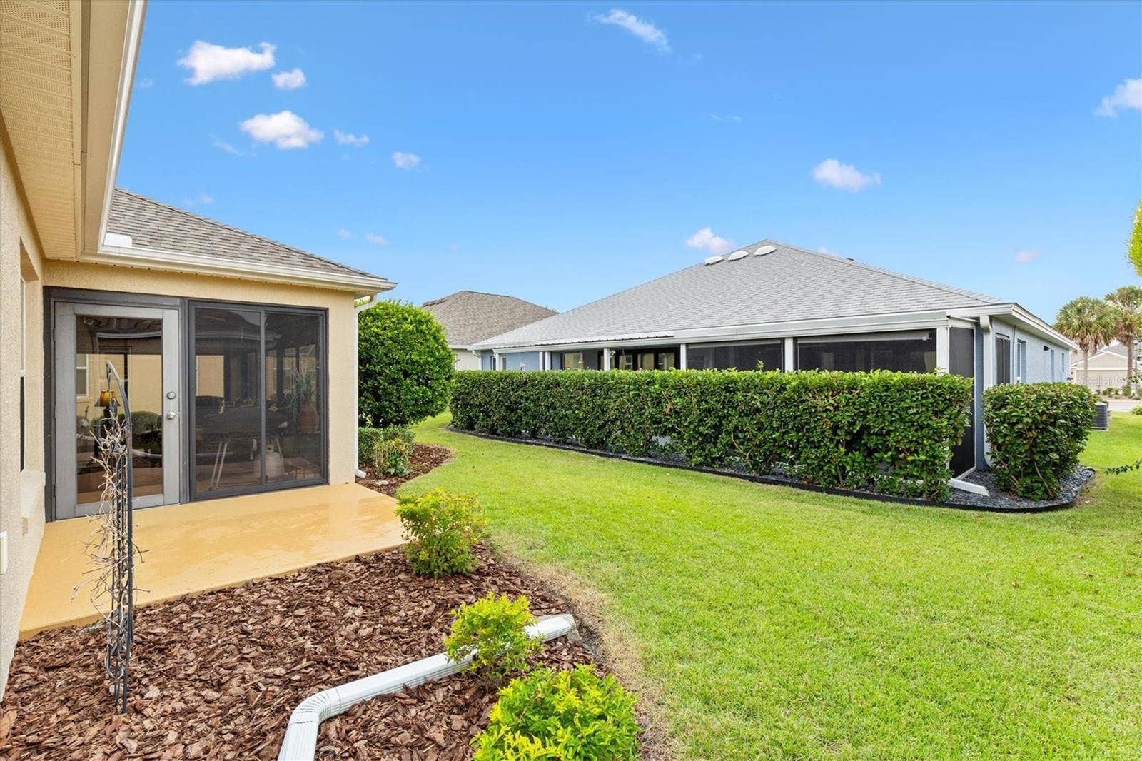 2346 GRENADIER WAY, The Villages, FL 32162 Side of Florida Room - Notice Neighbors Privacy Bushes