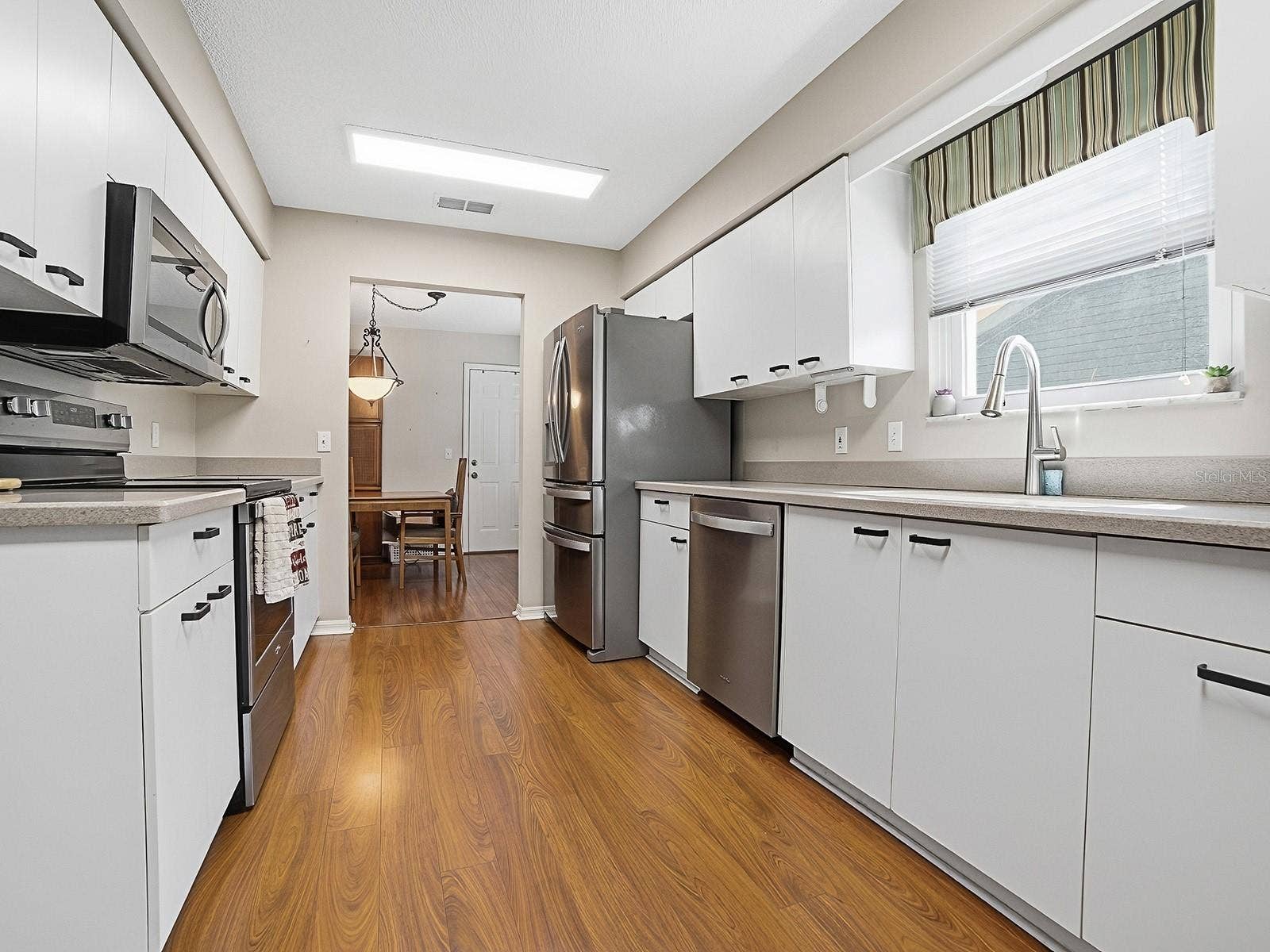 KITCHEN WITH NEWER STAINLESS STEEL APPLIANCES