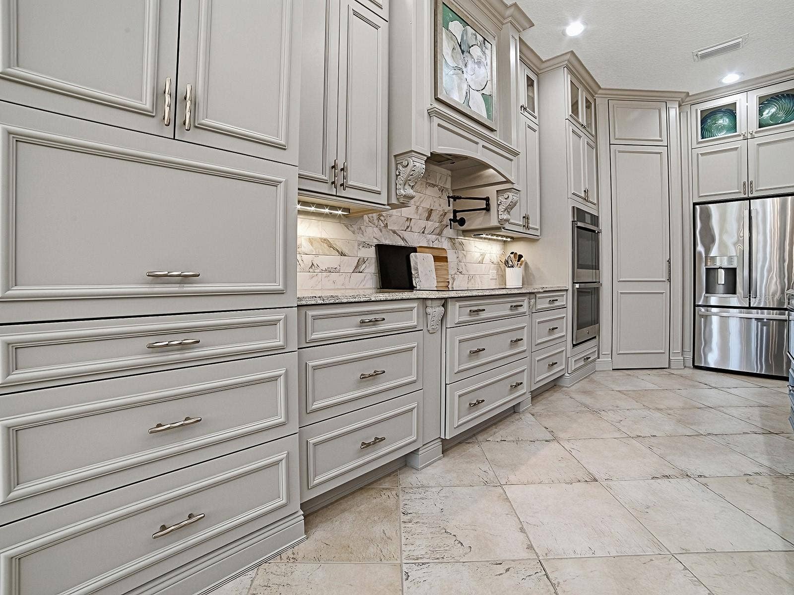 1103 MIONA SHORES DRIVE, The Villages, FL 32162 THE APPLIANCE GARAGE CLOSED IN THIS PHOTO, LOVELY TILED BACKSPLASH AND MANY LIGHTING OPTIONS.