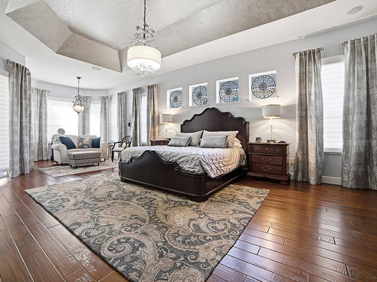1103 MIONA SHORES DRIVE, The Villages, FL 32162 PRIMARY BEDROOM - WOW! HARDWOOD FLOORING, CUSTOM DRAPES, CUSTOM FIXTURES - A SPECTACULAR, SPACIOUS ROOM!
