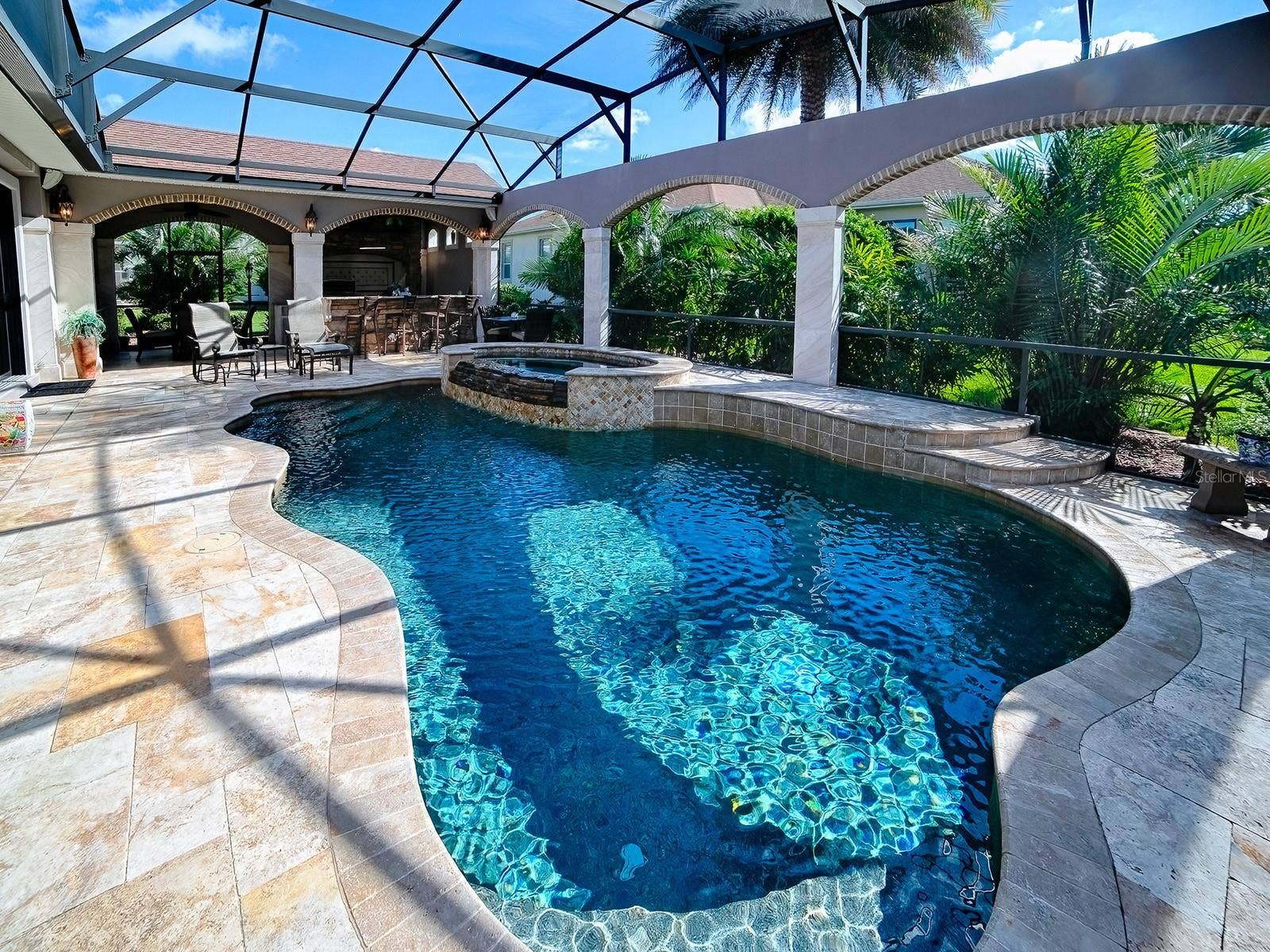 1103 MIONA SHORES DRIVE, The Villages, FL 32162 BEAUTIFUL TRAVERTINE DECKING AND TRAVERTINE COLUMNS WITH BRICK ACCENTS.