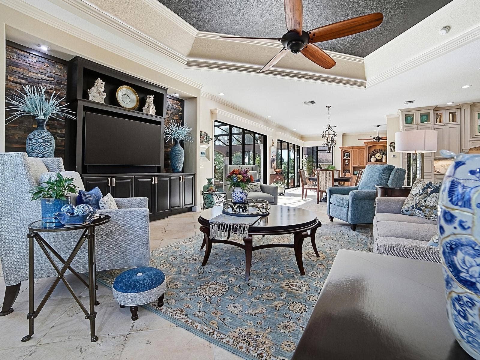 1103 MIONA SHORES DRIVE, The Villages, FL 32162 WHAT A BEAUTIFUL FAMILY ROOM WITH CUSTOM BRICK WALL SURROUNDING THE BUILT IN WALL UNIT AND CABINETS.