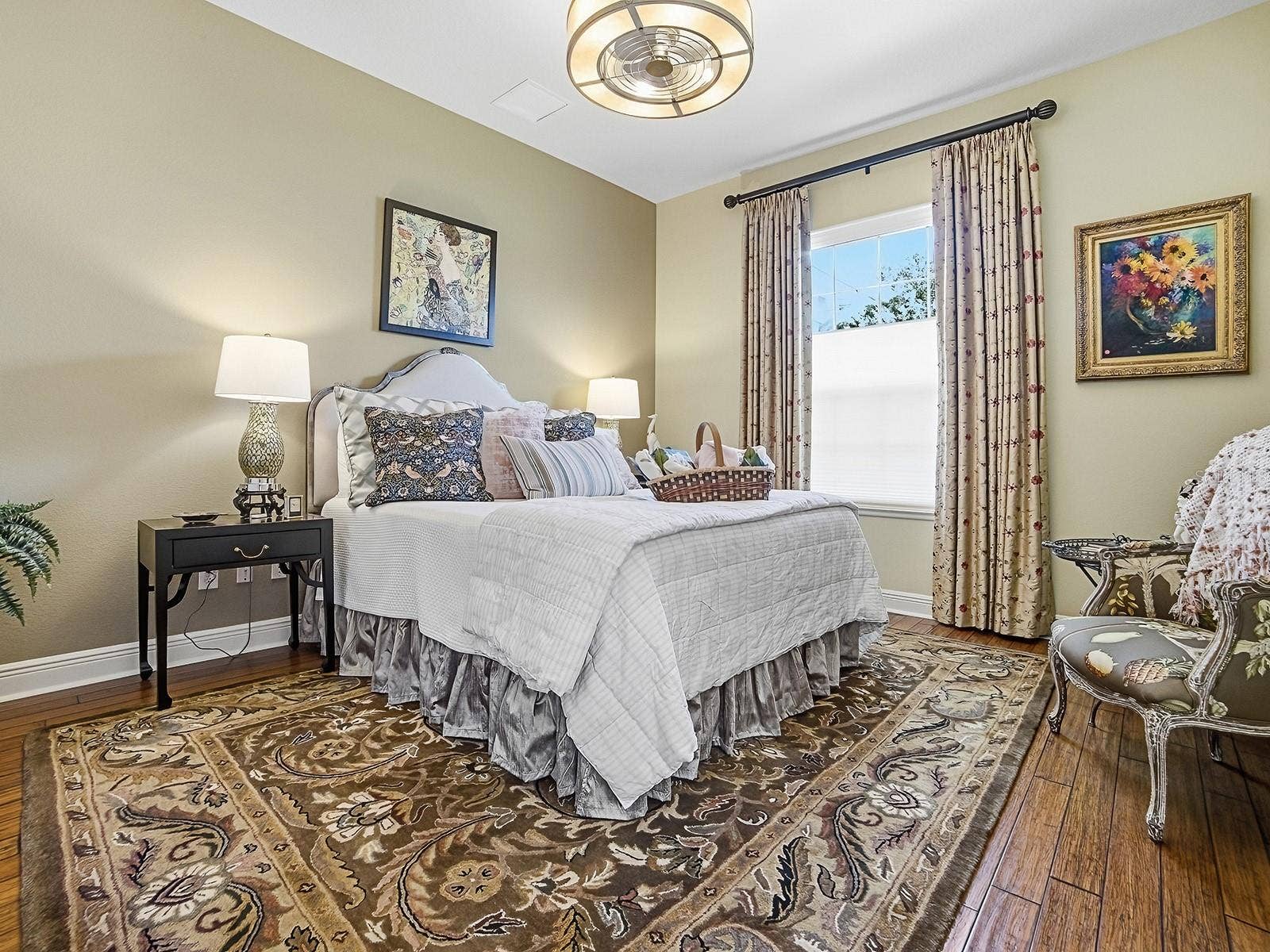 1103 MIONA SHORES DRIVE, The Villages, FL 32162 LOVELY GUEST ROOM ON THE OPPOSITE SIDE OF THE HOME WITH HARDWOOD FLOORING, CUSTOM DRAPES, AND NEW FANDELIER LIGHT FIXTURE.