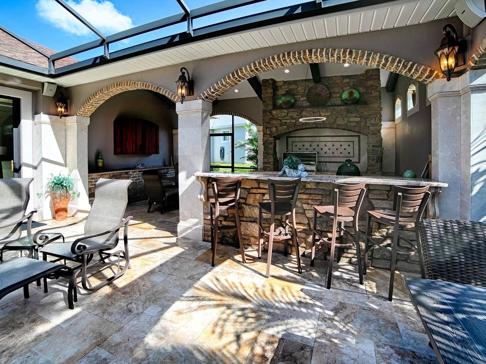 1103 MIONA SHORES DRIVE, The Villages, FL 32162 A GREAT PLACE FOR ENTERTAINING WITH THE SUMMER KITCHEN OFFERING AN ALFREDO GRILL AND REFRIGERATOR.