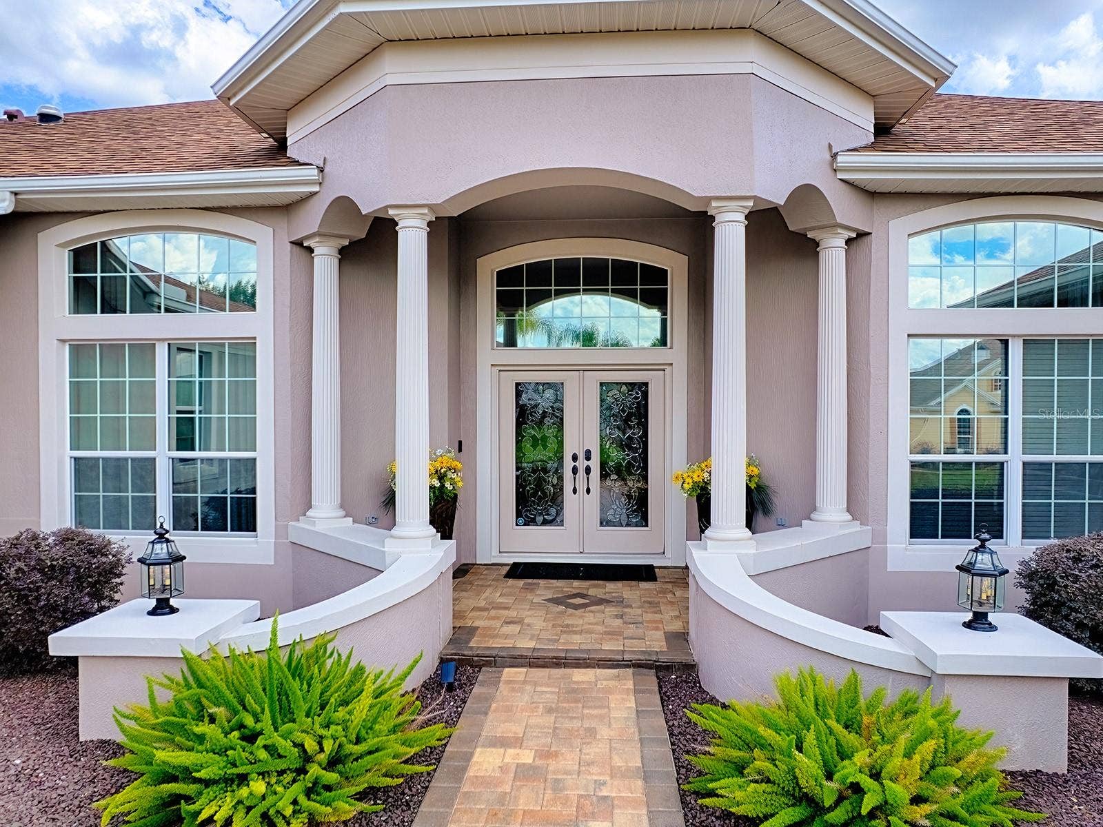 1103 MIONA SHORES DRIVE, The Villages, FL 32162 INVITING ENTRANCE WITH PAVERED WALKWAY, FRONT PORCH, AND LEADED GLASS FRONT DOORS!